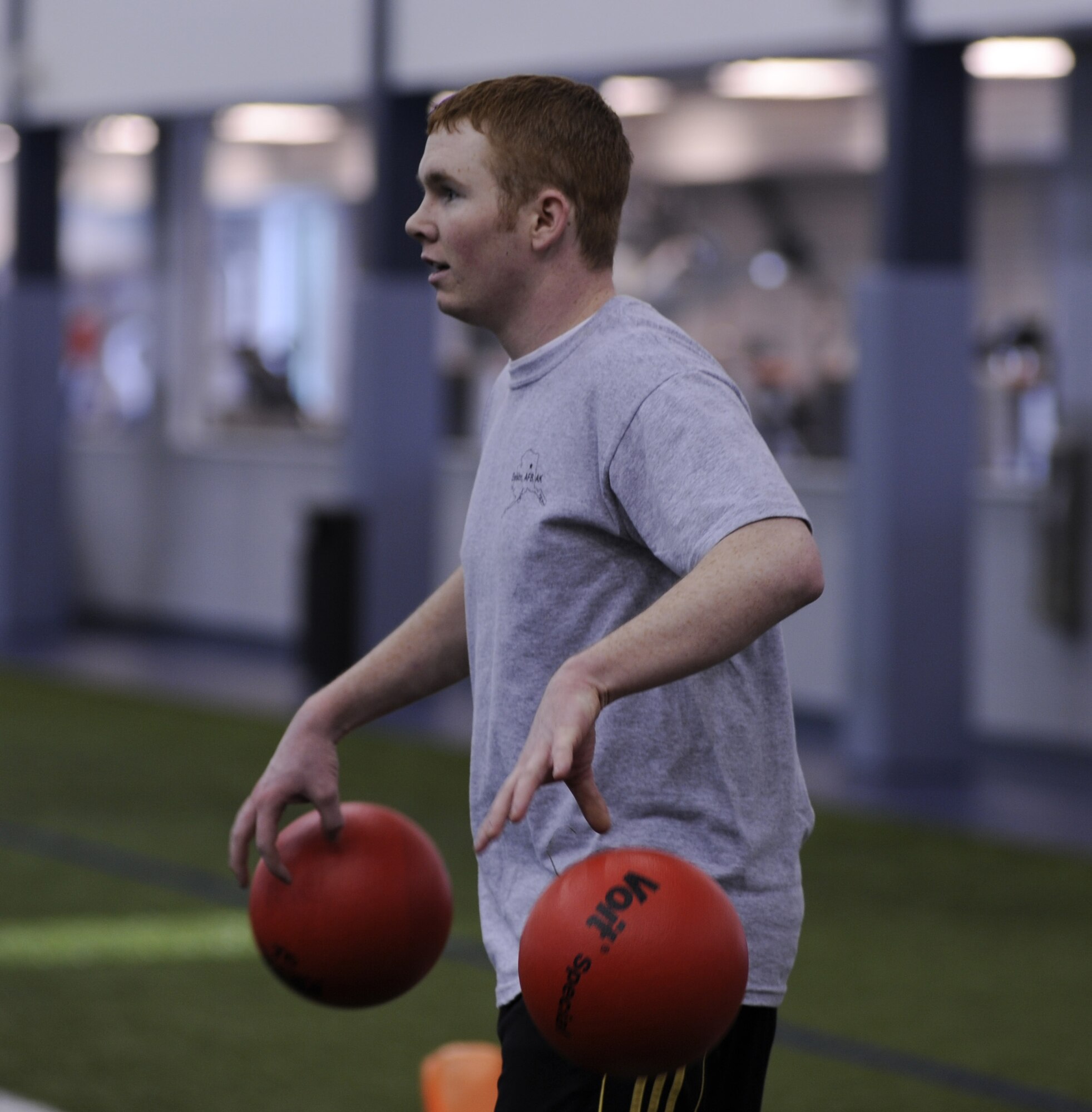 Airman 1st Class Justin Couch, 354th Fighter Wing Logistics Readiness Squadron, arms himself with two balls Feb. 27, 2009, Eielson Air Force Base, Alaska.  Airman Couch put up a good game before being defeated by the Air National Guard. The Force Support Squadron invited Airmen to play dodgeball and enjoy refreshments after the game during Customer Appreciation week.  (U.S. Air Force photo/Airman 1st Class Laura Max)