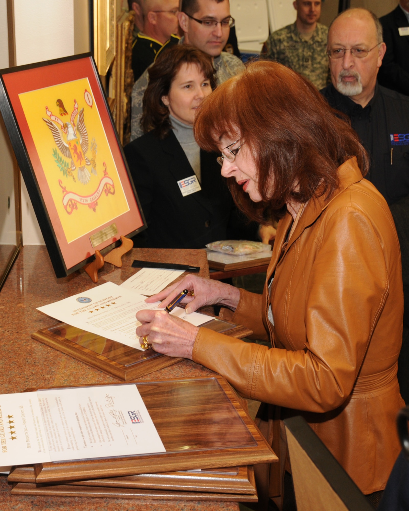 Regina Roth of Beef Products Incorporated (BPI) signs one of five Statements of Support on the National Guard and Reserve at the BPI headquarters in Dakota Dunes, South Dakota. The Statements of support represent the states where BPI has facilities; South Dakota, Iowa, Nebraska, Kansas and Texas.

USAF Photo by: Vincent De Groot 185th ARW Public Affairs
