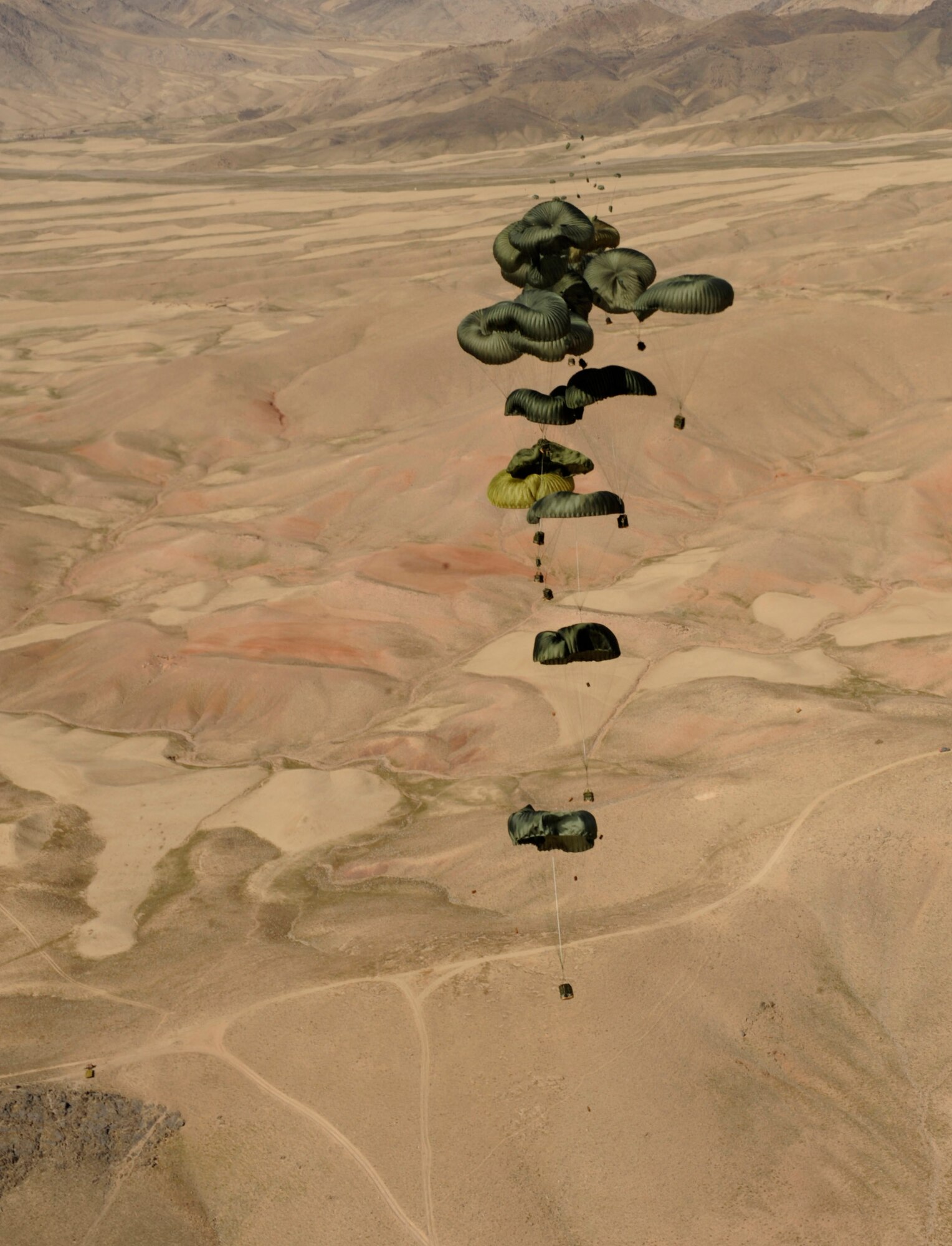 Container delivery system bundles fall to the drop zone after exiting an 816th Expeditionary Airlift Squadron C-17 Globemaster III during a high-altitude airdrop mission Feb. 14 in Afghanistan. (U.S. Air Force photo/Staff Sgt. James L. Harper Jr.)