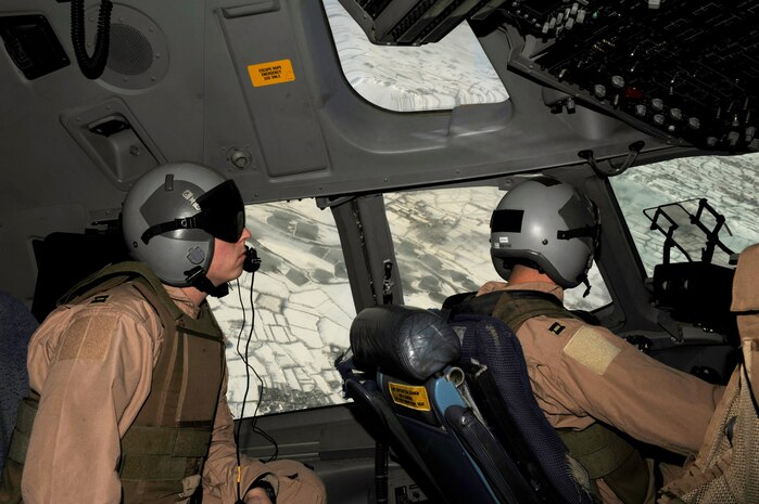 Captain Matt Pinkerton (left) scans the horizon while Capt. Joe Beal (right) flies a mission in a C-17 Globemaster III Feb. 14 over Afghanistan. Captains Pinkerton and Beal are C-17 pilots from the 816th Expeditionary Airlift Squadron. (U.S. Air Force photo/Staff Sgt. James L. Harper Jr.)