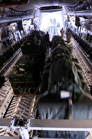 A C-17 Globemaster III aircrew from the 816th Expeditionary Airlift Squadron loads container delivery system bundles onto the aircraft prior to an airdrop mission Feb. 14 in Afghanistan. (U.S. Air Force photo/Staff Sgt. James L. Harper Jr.)