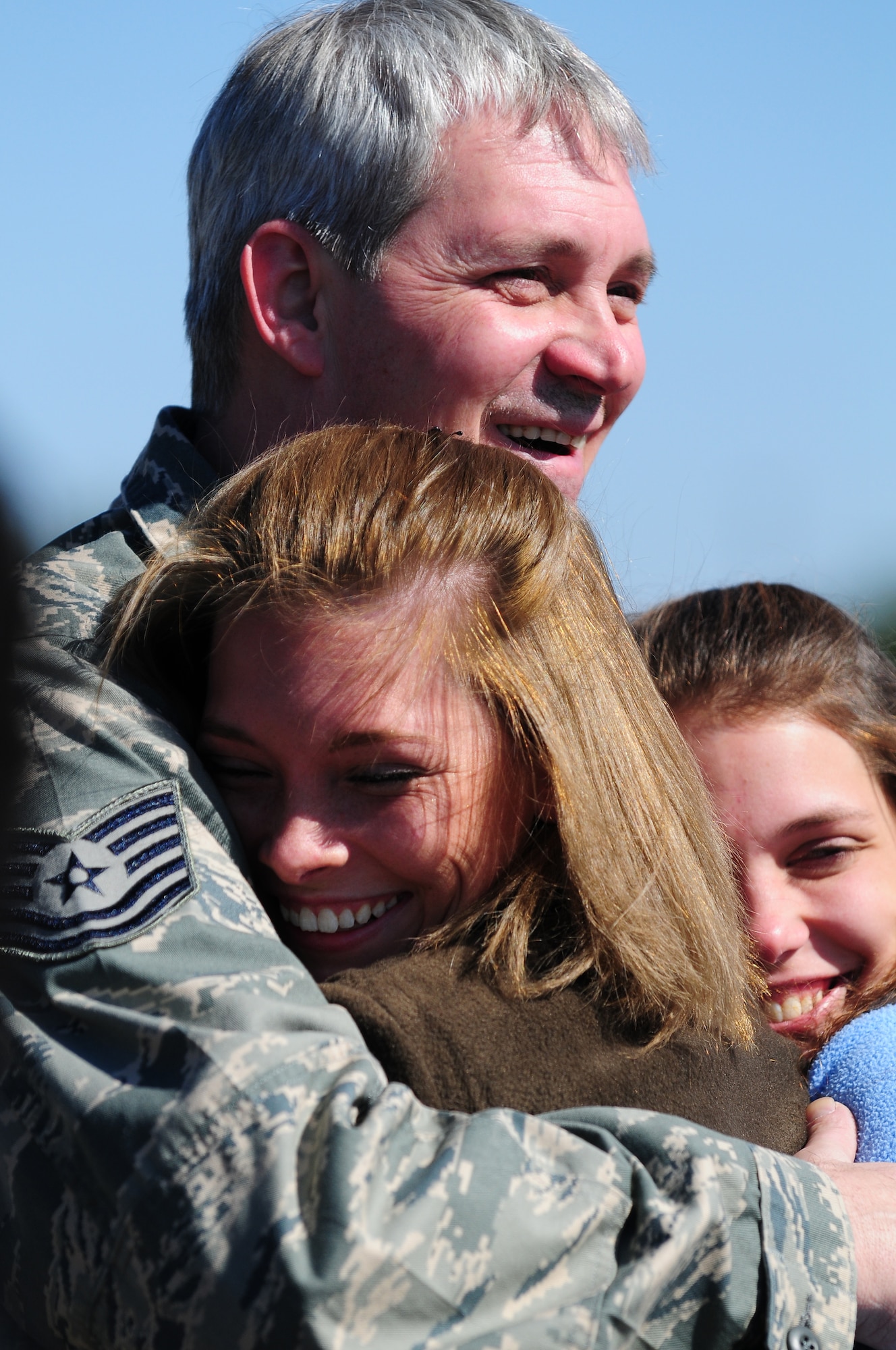 Stepping off a C-130 at Maxwell Feb. 21,Tech. Sgt. Jeff Harris receives an enthusiastic welcome from his daughters, Amanda and Brittnie. Sergeant Harris was one of 60 aircrew and maintenance members of Maxwell’s 908th Airlift Wing that deployed for three weeks to Europe, flying missions out of Ramstein, Germany. An Air Force Reserve wing, the 908th flies and maintains eight C-130H aircraft. (Air Force photo by Master Sgt. Scott Moorman)