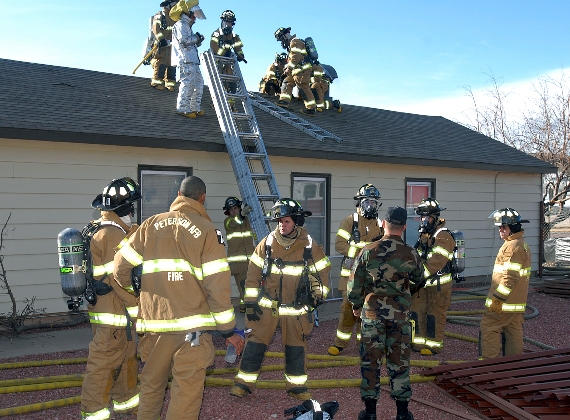 New 21st Space Wing firefighters get an opportunity to sharpen their emergency response skills Feb. 25 on a building set for demolition here.  Building 880 was the scene of a simulated home attic fire.  This type of training is crucial to ensuring the safety of incident or accident victims and the safety of the first responders themselves. The Peterson Fire Department stands ready every day to provide emergency support to the base’s 51 tenant units.