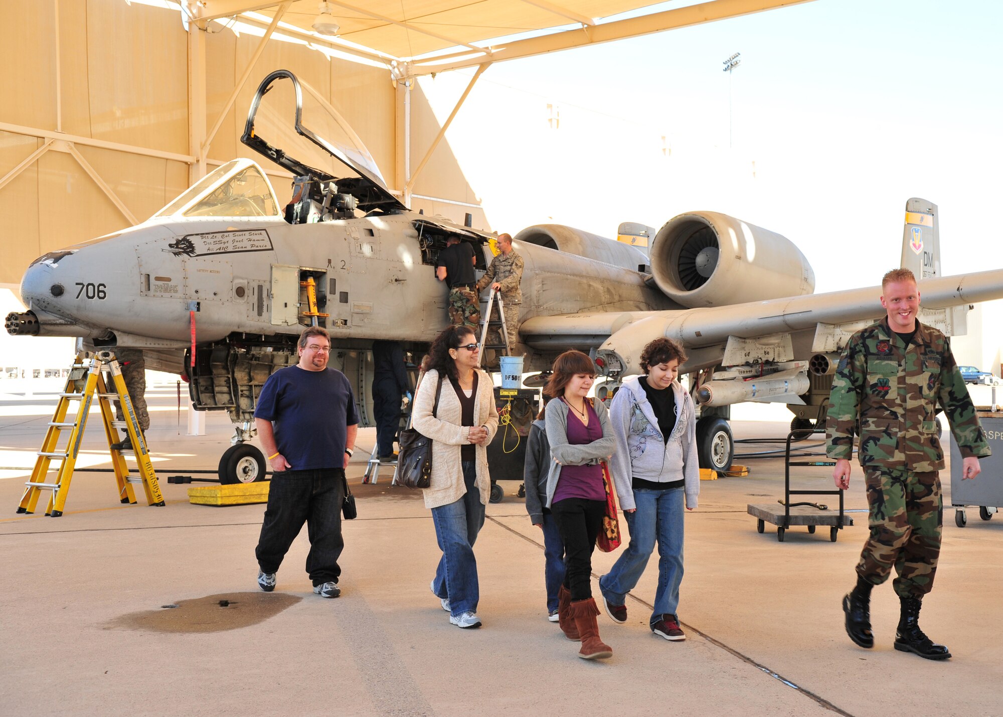 Staff Sgt. Joshua Adams (right) of the 355th Aircraft Maintenance Squadron, shows Pilot For a Day Cassy Eubanks (second from right) along with her family an A-10 during their visit to D-M Feb. 20. The Pilot For A Day program is designed to help children with disabilities or serious illnesses enjoy a day focused on them and their interest in aviation. (U.S. Air Force photo/Senior Airman Noah R. Johnson)