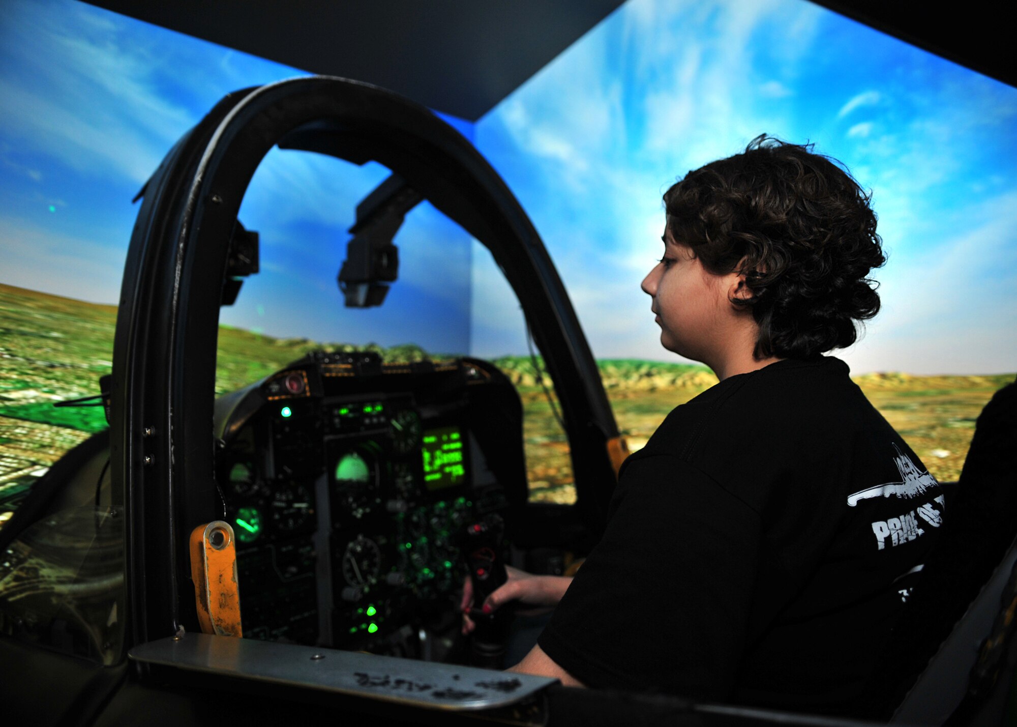 Pilot For a Day Cassy Eubanks, 18 years old, flies an A-10 flight simulator during her visit to D-M Feb. 20. The Pilot For A Day program is designed to help children with disabilities or serious illnesses enjoy a day focused on them and their interest in aviation. (U.S. Air Force photo/Senior Airman Noah R. Johnson)