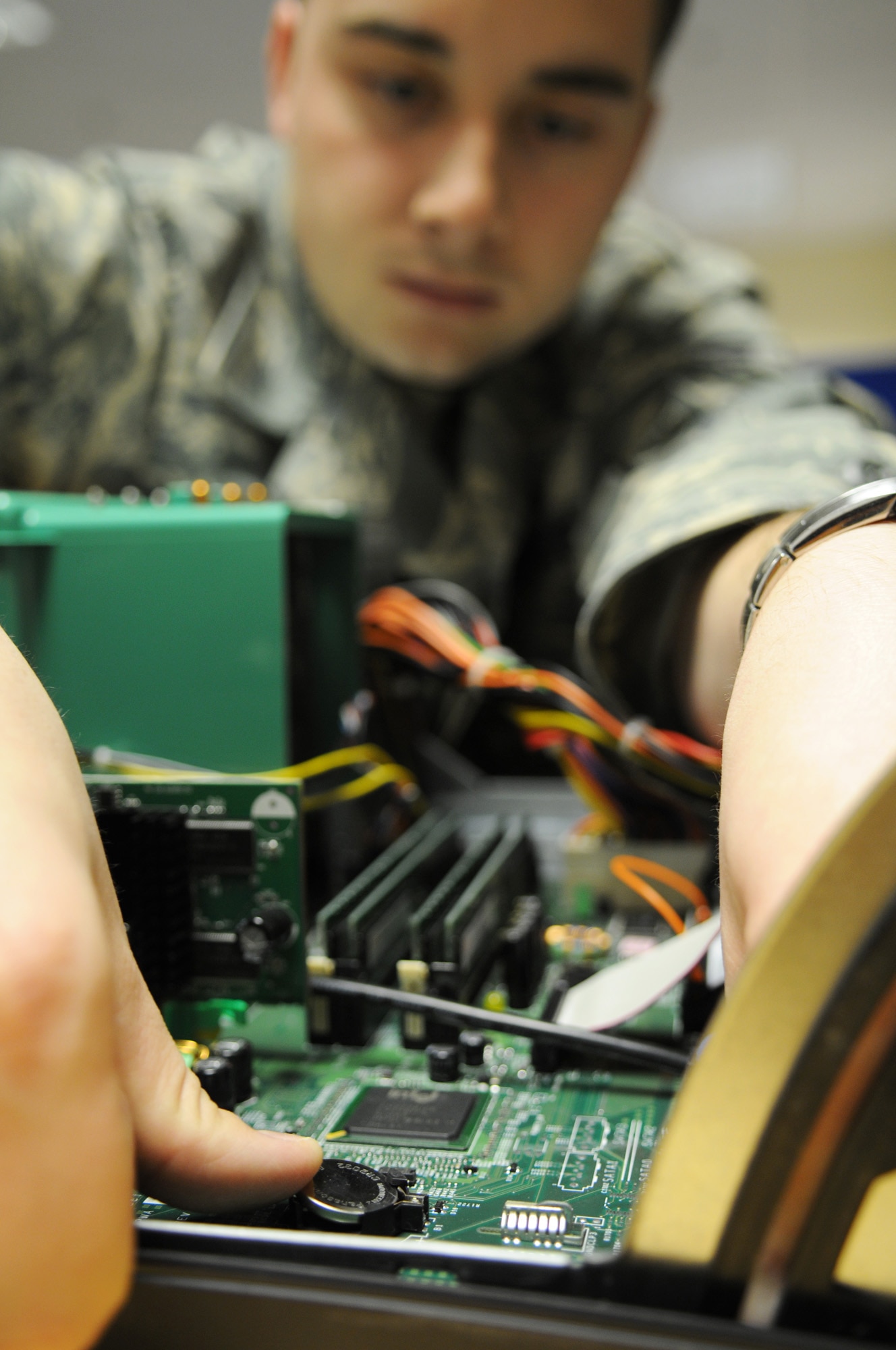 Senior Airman Andrew Blasiman, a 100th Communications Squadron network infrastructure technician journeyman, replaces a small battery inside a computer Feb.25, 2009, at RAF Mildenhall, England. The purpose of the battery is to accurately keep track of time whether the computer has power to it or not. (U.S. Air Force photo by Staff Sgt. Jerry Fleshman) 