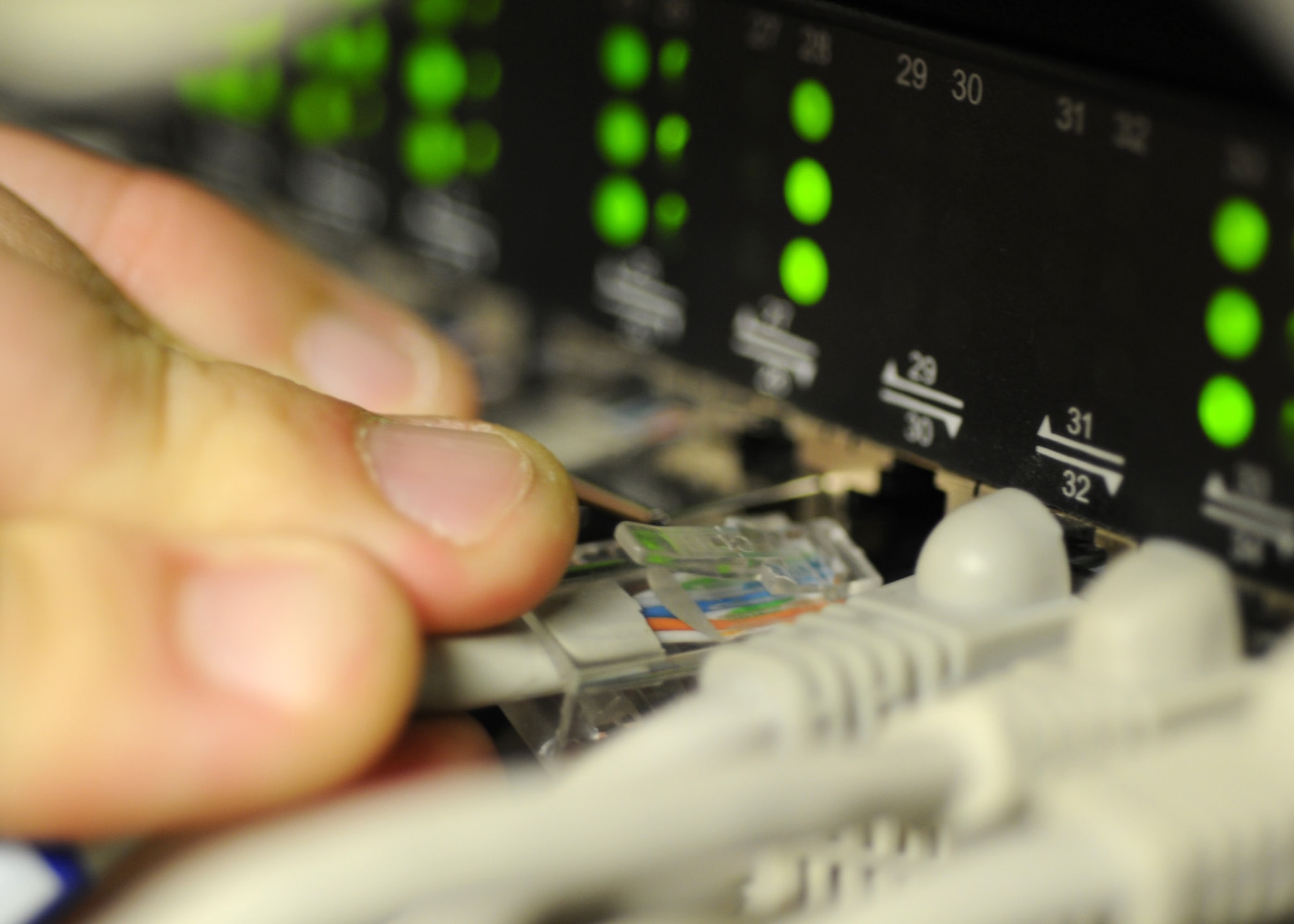 Senior Airman Andrew Blasiman, a 100th Communications Squadron network infrastructure technician journeyman, installs a CAT 5 cable into a server Feb. 25, 2009, at RAF Mildenhall, England. The Communications Squadron provides a wide variety of services making any and all communication throughout RAF Mildenhall possible. (U.S. Air Force photo by Staff Sgt. Jerry Fleshman)