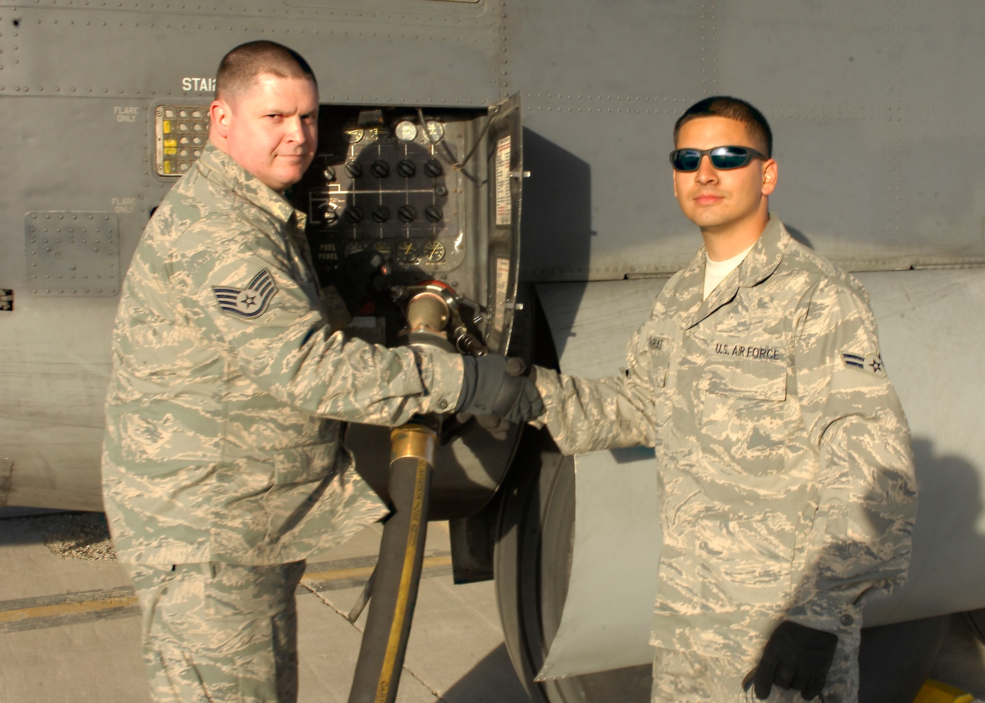 Staff Sgt. Jason Sands, 919th Aircraft Maintenance Squadron, Special Operations Command congratulates  as Airman 1st Class Jimmy Farias, 455th Expeditionary Logistics Readiness Squadron, as he passes 1 million gallons at Bagram Air Field, Afghanistan, Feb. 27. Airman Farias arrived to BAF on 4 Jan., within 52 days on station he set the record which was previously done in 56 days. Airman Farias said, " I'm proud, knowing that I contributed to the success of our overall mission." Airman Farias is deployed from Elmendorf Air Force Base, Alaska and hails from Dallas, Texas. Sergeant Sands is deployed from Duke Field, Fla. and hails from Pensacola, Fla.(U.S. Air Force photo/ Senior Airman Erik Cardenas)(Released)