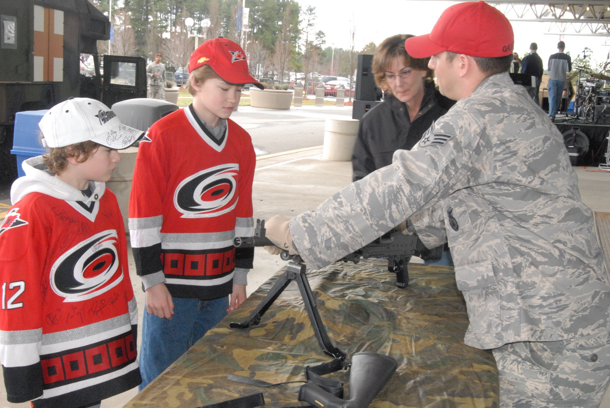 Senior Airman Daniel Ganus, 43rd Security Forces Squadron, talks to spectators about security forces weapons prior to the Carolina Hurricanes Military Appreciation Game VS the Colorado Avalanche, Feb. 22, 2009 at the RBC Center in Raleigh, N.C. (U.S Air Force Photo by Tech. Sgt. Todd Wivell)