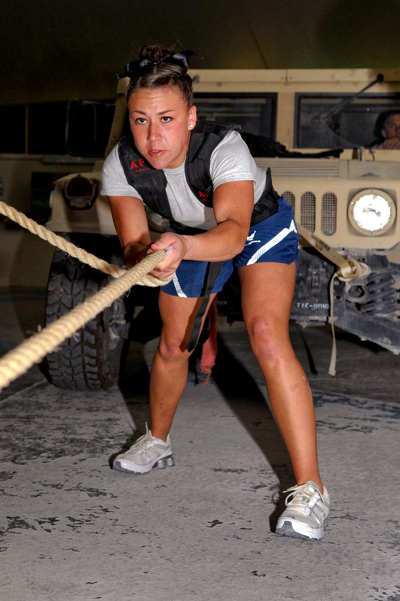 Airman 1st Class Nicole Yarak, from the 816th Raven Team, prepares to pull a Humvee during the Strongman Competition here, Feb. 28, 2009, in an undisclosed location in Southwest Asia.  Airman Yarak was the only female to participate in the event which tested the strength and muscle endurance of the competitors.  Airman Yarak hails from Roseville, Calif. and is deployed from Travis Air Force Base, Calif. in support of Operations Iraqi and Enduring Freedom and Combined Joint Task Force - Horn of Africa. (U.S. Air Force Photo by Senior Airman Andrew Satran/released)