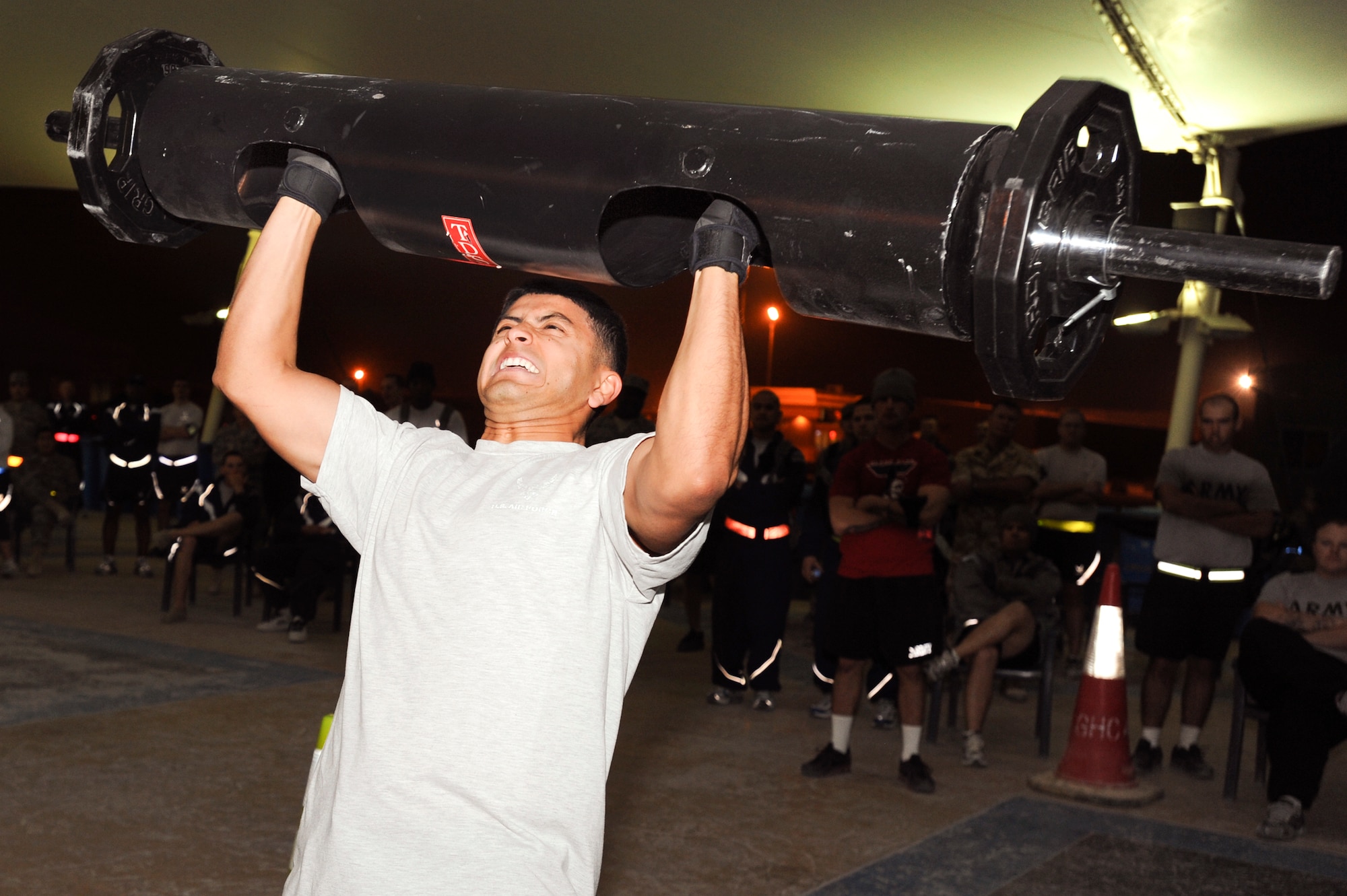 Senior Airman Rafael Vala, 379th Expeditionary Civil Engineer Squadron, strains as he performs a log press weighing 135 pounds during the Strongman Competition held here, Feb. 28, 2009, in an undisclosed location in Southwest Asia.  The competition tested the competitor's strength and muscle endurance through the course of several different events such as the log press.  Airman Vela is native to Houston, Texas and is deployed from Travis Air Force Base, Calif. in support of Operations Iraqi and Enduring Freedom and Combined Joint Task Force - Horn of Africa.  (U.S. Air Force Photo by Staff Sgt. Joshua Garcia/released)