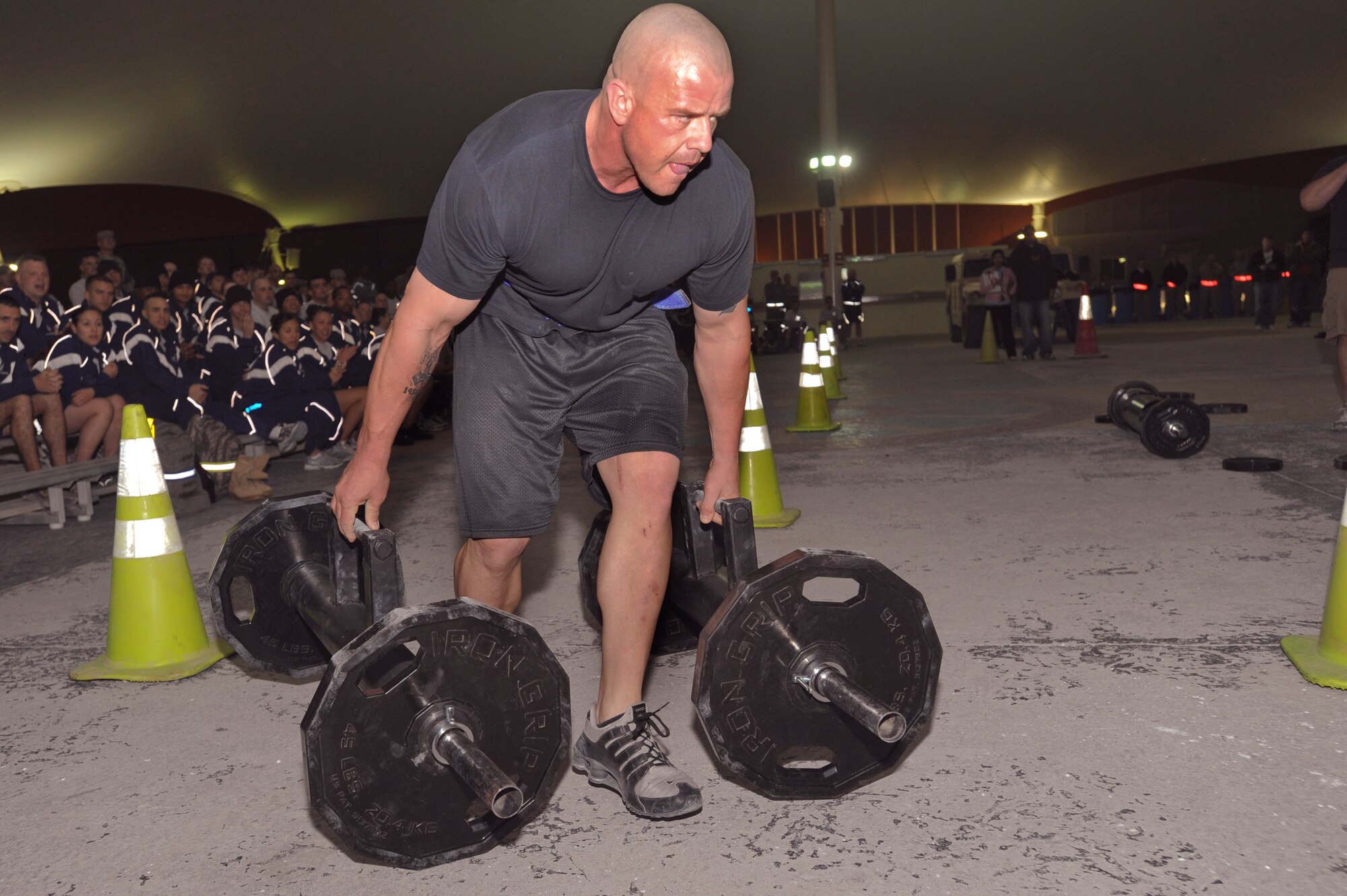 Christopher Tyler, the Fitness Manager for the 379th Expeditionary Force Support Squadron, moves on to the next part of the relay race during the Strongman Competition held here, Feb. 28, 2009, in an undisclosed location in Southwest Asia.  Mr. Tyler joined in on some of the events to help motivate the other entrants in the competition.  Mr. Tyler hails from Killeen, Texas and is stationed here as a civilian contractor in support of Operations Iraqi and Enduring Freedom and Combined Joint Task Force - Horn of Africa.  (U.S. Air Force Photo by Staff Sgt. Joshua Garcia/released)