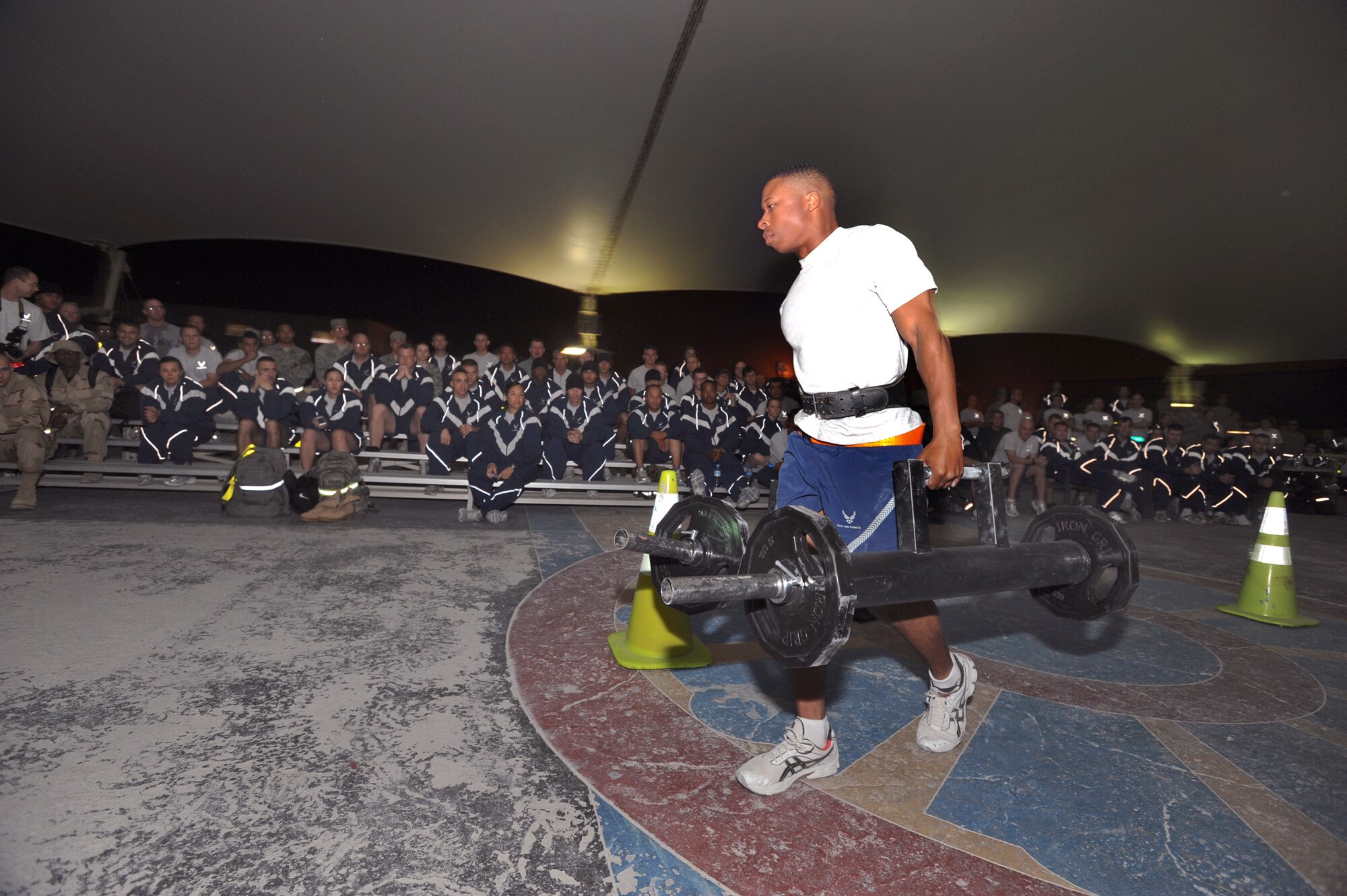 Senior Airman Beau Faulk, from 379th Expeditionary Civil Engineer Squadron, carries 85 pounds on each arm during a relay race for the Strongman Competition held here, Feb. 28, 2009, in an undisclosed location in Southwest Asia.  The competition offered several events for entrants to compete in to see who the strongest man on base is.  Airman Faust is native to Jacksonville, N.C. and is deployed from Travis Air Force Base, Calif. in support of Operations Iraqi and Enduring Freedom and Combined Joint Task Force - Horn of Africa. (U.S. Air Force Photo by Staff Sgt. Joshua Garcia/released)