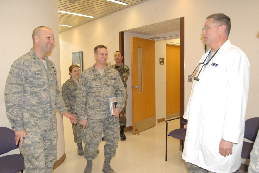 Brig. Gen. Douglas Robb, Command Surgeon for Headquarters Air Mobility Command, Scott Air Force Base, Ill., and Col. Paul Martin, 43rd Medical Group Commander, talk to Dr. (Lt. Col.) Phillip Portera, 43rd Aerospace Medicine Squadron, during a visit to the Pope Dental Clinic Feb. 24 (U.S. Air Force Photo by Airman 1st Class Mindy Bloem)