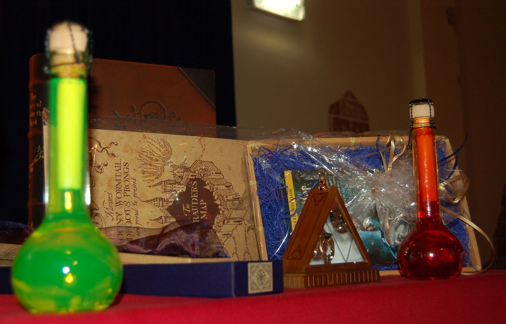 SPANGDAHLEM AIR BASE, Germany – Prizes for outstanding performance and mere luck of the drawl line a table at the Harry Potter Convention at the Brick House Feb. 28, 2009. The prizes ranged from a limited edition Tales of Beedle Bard book to Slytherin's Deathly Hallows ring. The convention featured a Quidditch tournament, a Bertie Bott's Every Flavor Beans eating contest, house sorting and more. (U.S. Air Force photo by Staff Sgt. Tammie Moore)