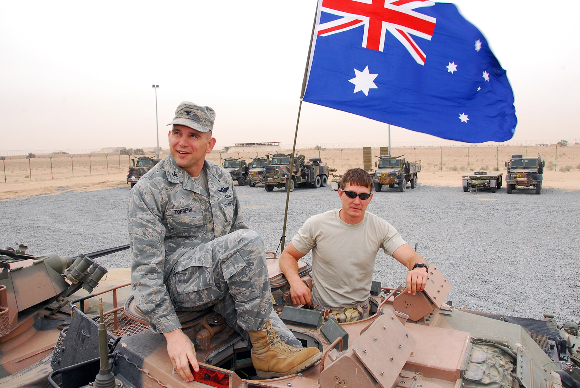 SOUTHWEST ASIA -- Col. Cameron Torrens, 386th Air Expedtionary Wing commander, takes a tour of an Australian Light Armored Vehicle at Force Support Unit 1's camp, Billabong Flats, at the Army Life Support Area Feb. 27. Australian Lt. Col. Ed Smeaton hosted the wing commander to thank him for 386th AEW Airmen's contributions to Victoria bushfire relief. (U.S. Air Force photo by Senior Airman Courtney Richardson)