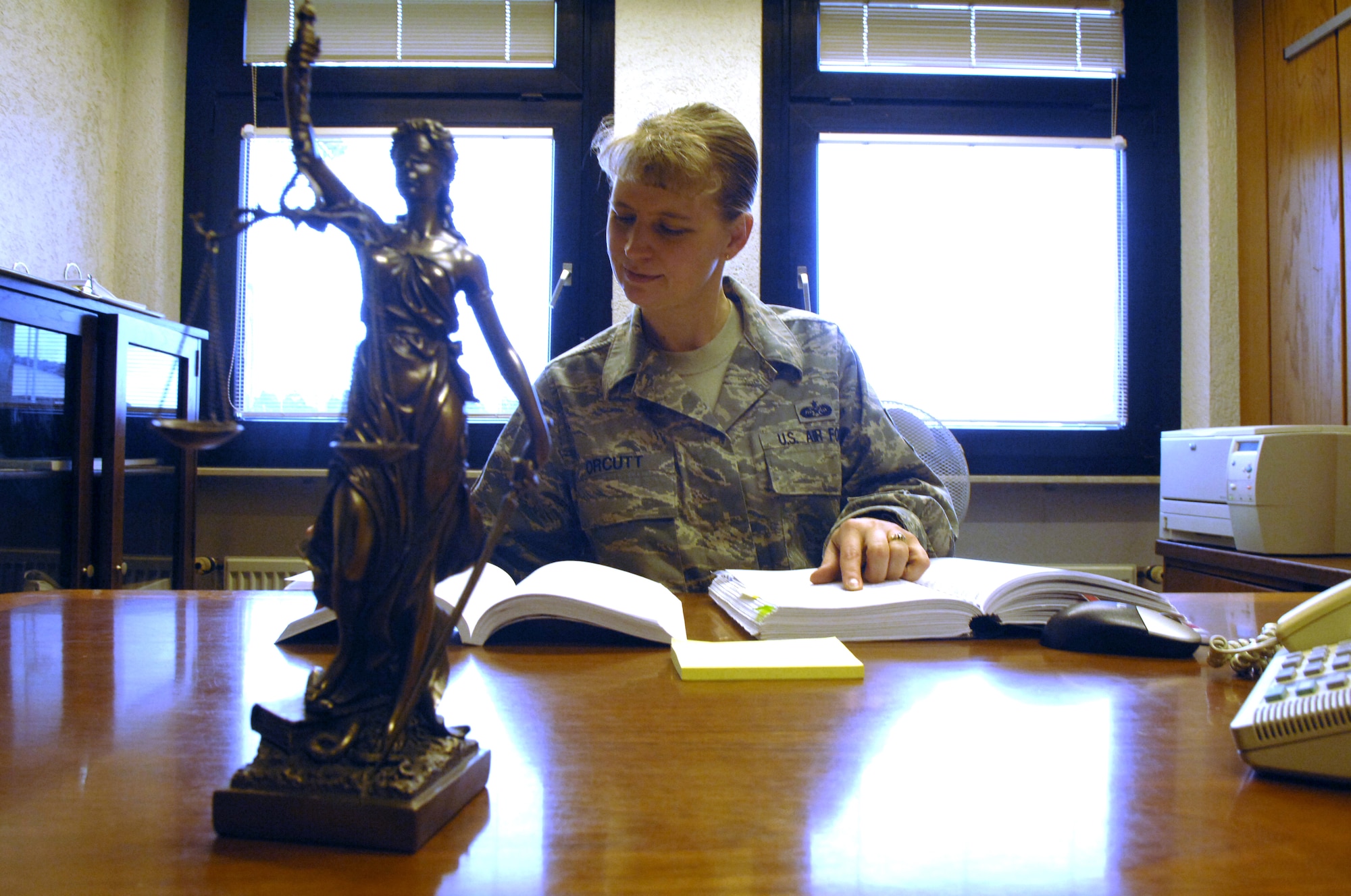 Master Sgt. Kristen Orcutt, 435th Air Base Wing paralegal reviews the Manual for Courts-Martial for court-martial case preparation.  Sergeant Orcutt, an 18 year Air Force veteran, retrained to be an Air Force paralegal eight years ago. (Air Force photo by Tech. Sgt. Michael Voss)