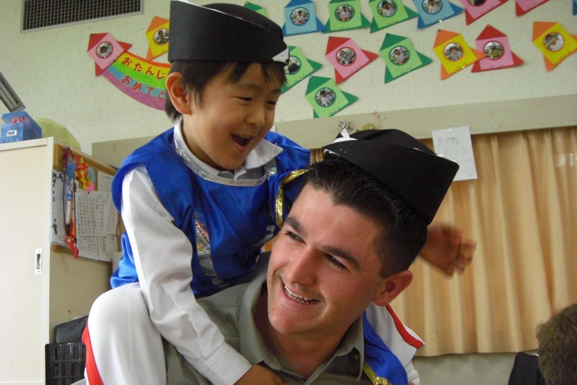 Airman 1st Class Jacob Davidson from the 18th Communication
Squadron plays with a child from the Isshin Preschool in Miyazaki
Prefecture, Japan, Feb. 26. 18th Wing Airmen volunteered to teach English
skills at the preschool during a week-long bilateral training event with the
Japan Air Self Defense Force at Nyutabaru Air Base Feb. 23-27. (Courtesy
Photo)
