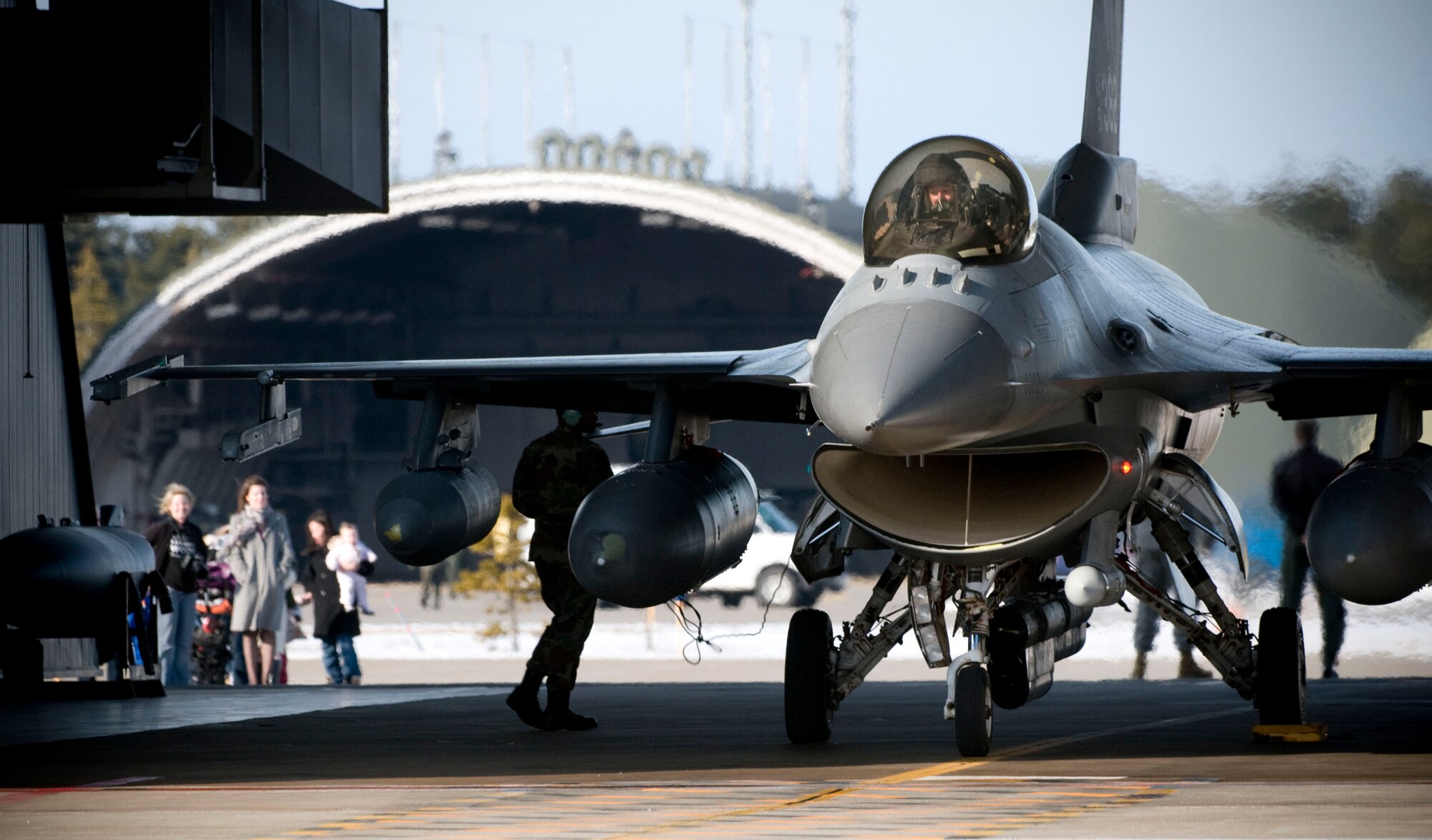 MISAWA AIR BASE, Japan -- An F-16 Fighting Falcon piloted by Capt. Andrew Gilmer, 14th Fighter Squadron, powers down Feb. 27, 2009. Captain Gilmer's wife Sharron waited off to the side of the jet with other friends and family to greet him at the plane. (U.S. Air Force photo by Staff Sgt. Samuel Morse)