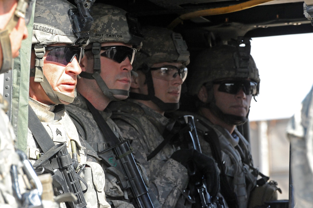 U.S. Army Sgt. Daniel Cooper, left, and fellow soldiers sit inside a UH-60 Black Hawk helicopter from which they will practice an assault, during Aerial Response Force Training on Forward Operating Base Loyalty in eastern Baghdad, Iraq, Feb. 25, 2009.