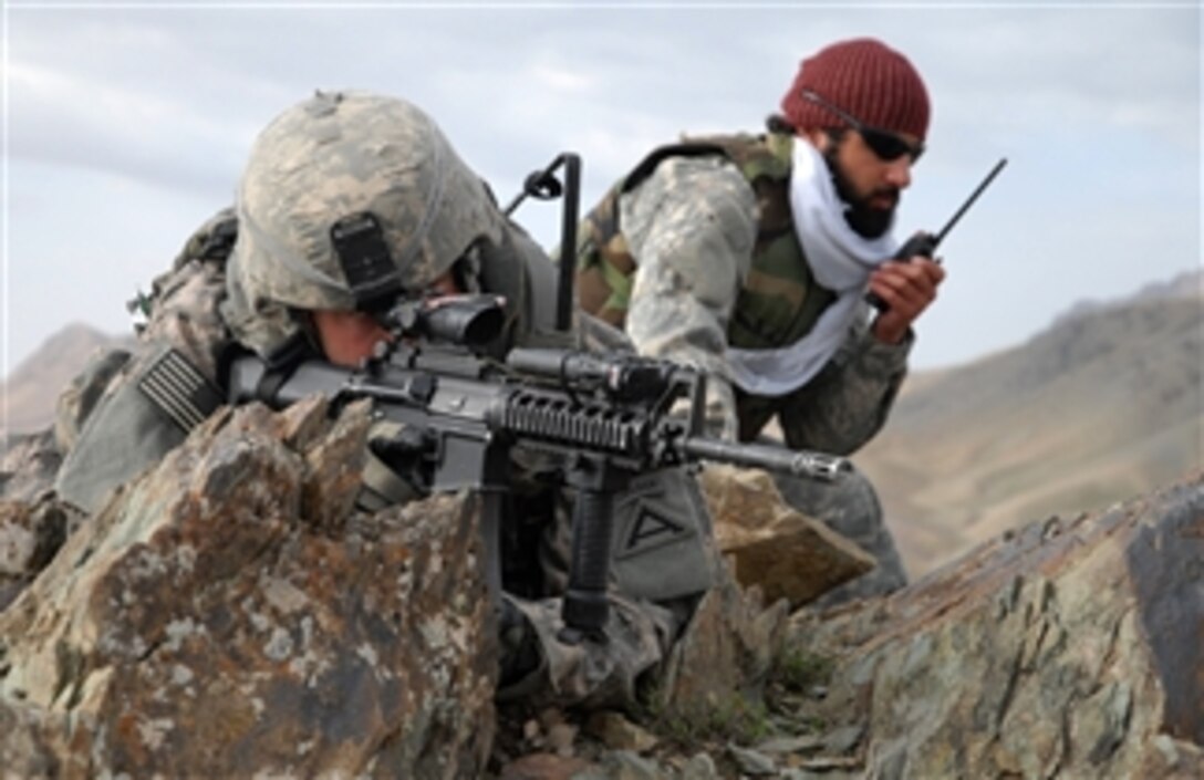 U.S. Army 1st Lt. Jared Tomberlin (left) and an interpreter provide security on top of a mountain ridge during a reconnaissance mission near Forward Operating Base Lane in the Zabul province of Afghanistan on Feb. 28, 2009.  Tomberlin is assigned to Bravo Company, 1st Battalion, 4th Infantry Regiment.  