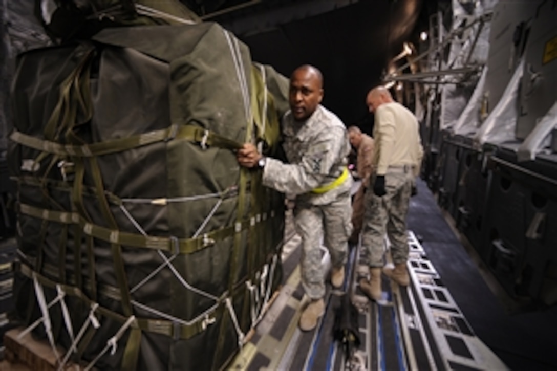 U.S. Army Sgt. Robert McNeely from the 824th Quartermaster Company (Aerial Delivery) loads a container delivery system of food onto a C-17 Globemaster III aircraft in Afghanistan prior to an airdrop on Feb. 27, 2009.  