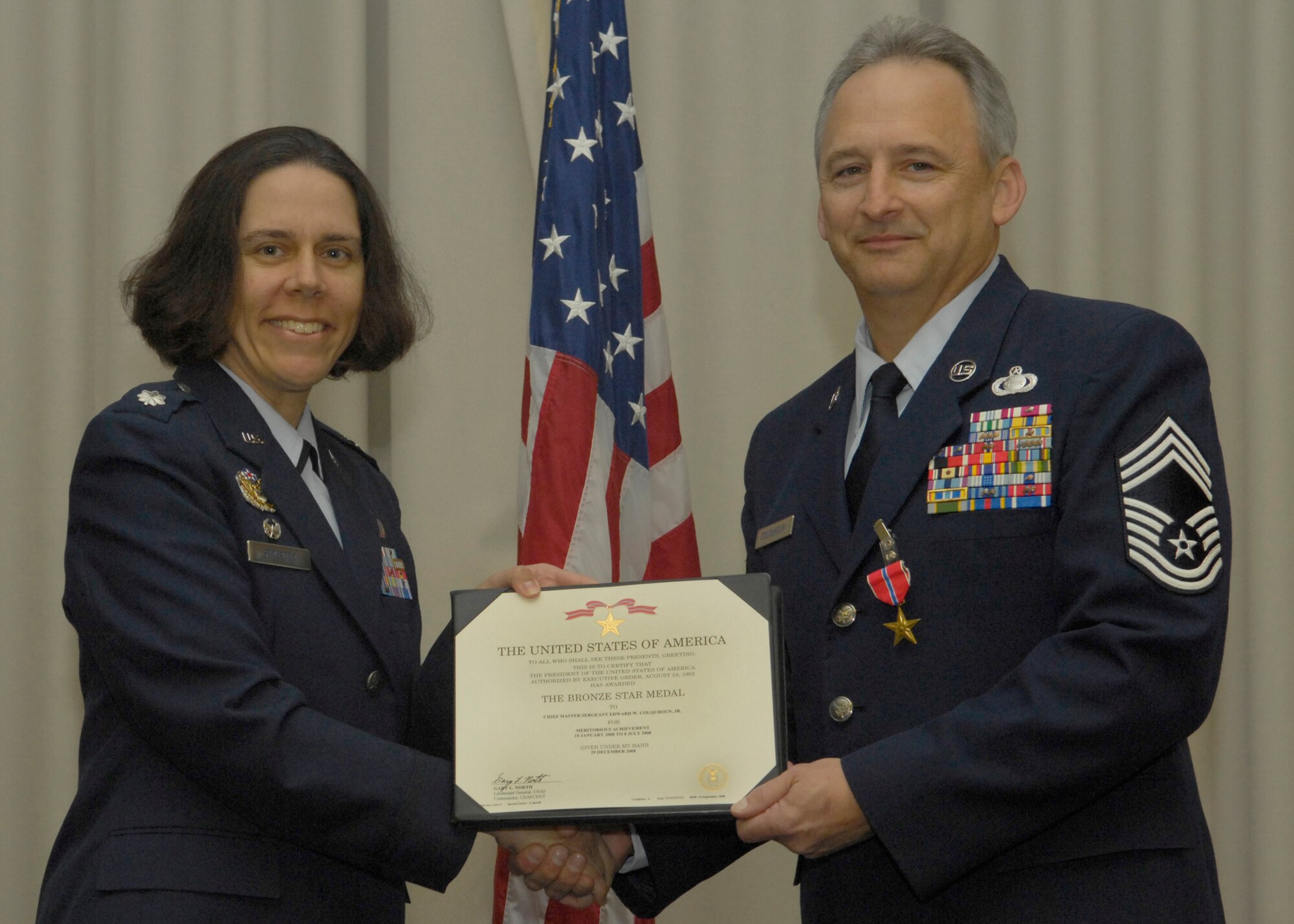 VANDENBERG AIR FORCE BASE, Calif. -- Retired Chief Master Sgt. Edward Colquhoun receives the Bronze Star Medal from Lt. Col. Suzanne Streeter, 18th Intelligence Squadron commander, here March 3. The Bronze Star Medal is awarded for acts of bravery, merit and meritorious service.  (U.S. Air Force photo/Airman 1st Class Andrew Lee) 
 