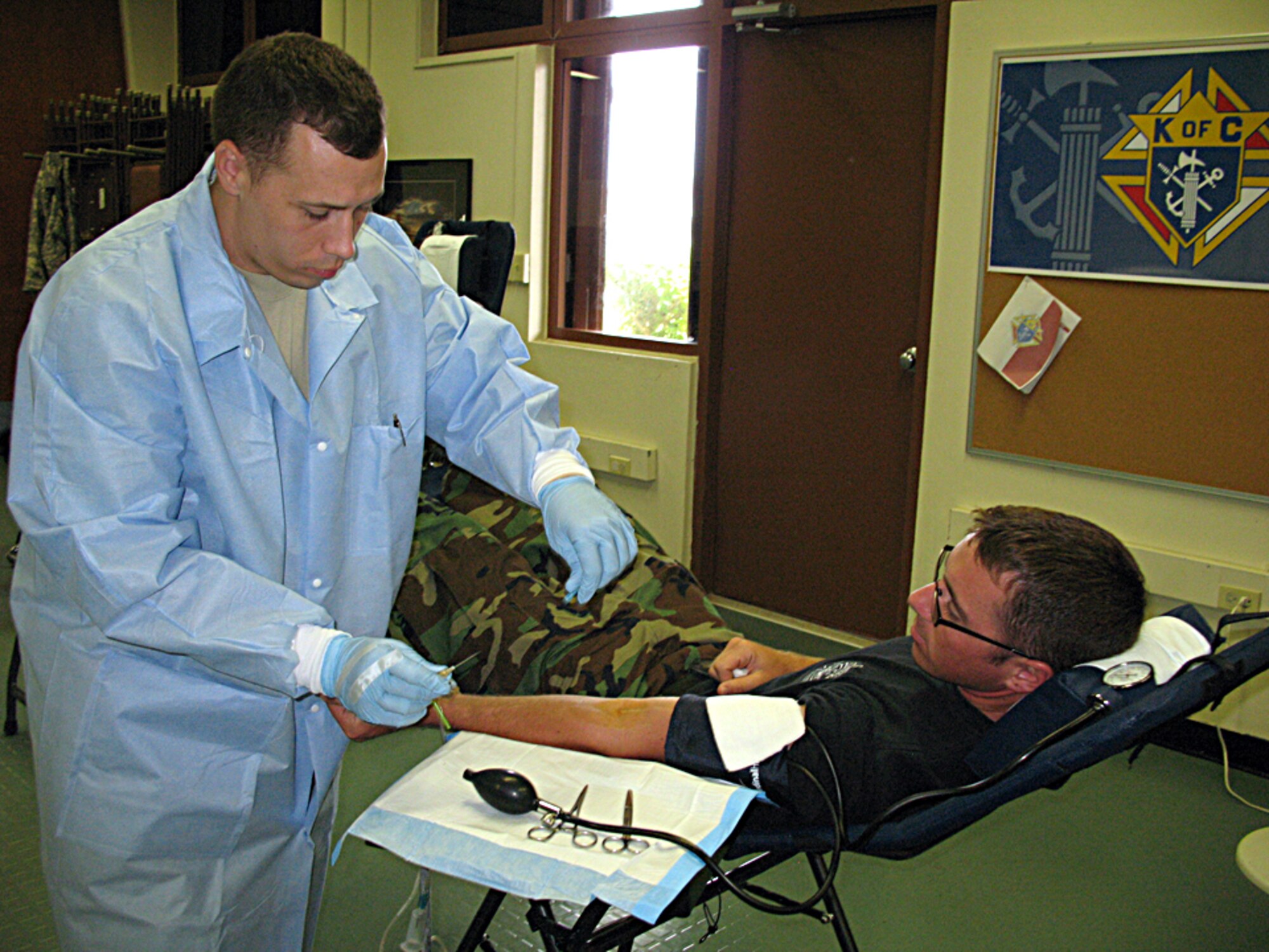ANDERSEN AIR FORCE BASE, Guam -- Air Force Staff Sgt. David Bates, Armed Forces Blood Bank Center, prepares to draw blood from Staff Sgt. Chalmers, 36th Civil Engineer Squadron firefighter, during the blood drive at the Chapel One Annex March 3. The Armed Forces Blood Bank Center is a joint service operation, with all branches of the military in its program. (U.S. Air Force photo by Airman 1st Class Carissa Wolff)