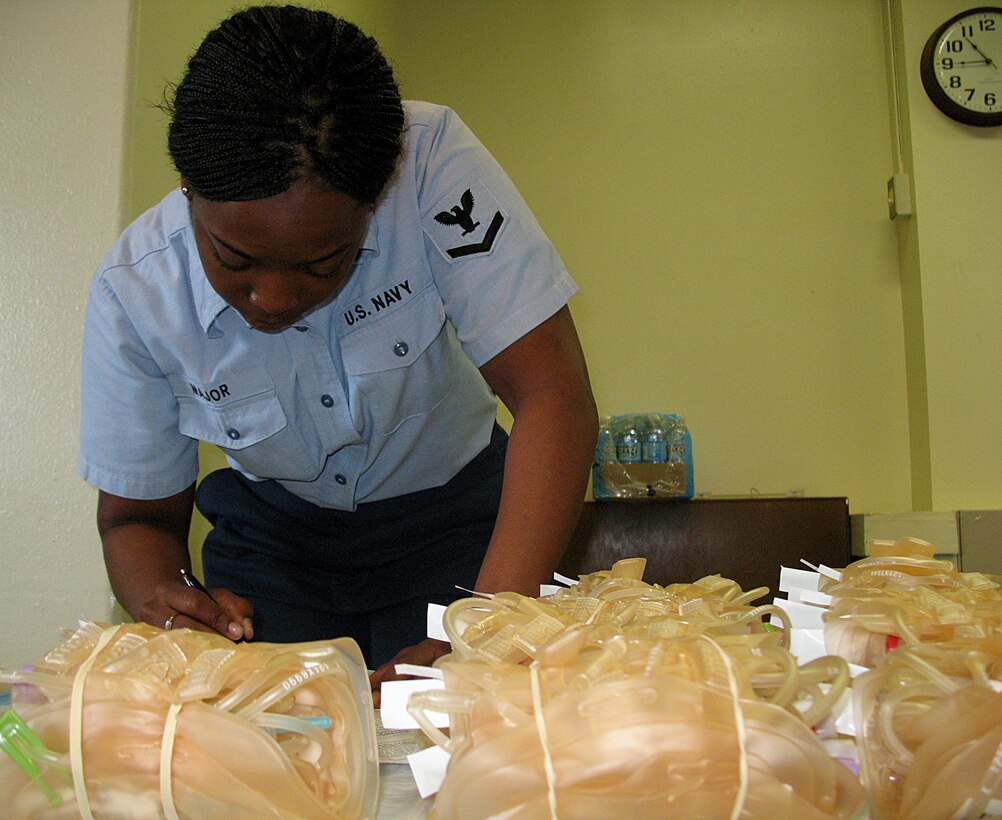 ANDERSEN AIR FORCE BASE, Guam -- Navy Petty Officer 3rd Class Calvanna Major, Armed Forces Blood Bank Center, prepares  and arranges paperwork and equipment to be used for blood donations during the blood drive at the Chapel One Annex March 3. The Armed Forces Blood Bank Center is a joint service operation, with all branches of the military in its program.(U.S. Air Force photo by Airman 1st Class Carissa Wolff)
