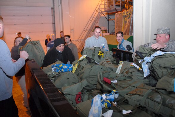 ELMENDORF AIR FORCE BASE, Alaska -- Members of the 477th Civil Engineer Squadron stack A-Bags in a vehicle as the unit leaves for their deployment Monday night. This is the first deployment for the 477 CES since World War II.  They are the only Air Force Reserve Civil Engineer Squadron in Alaska and are assigned to the 477th Fighter Group. (US Air Force Photo by Staff Sgt. Rhiannon Willard)