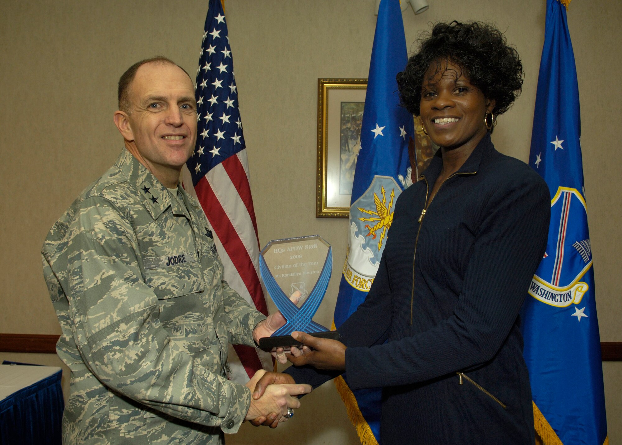 Maj. Gen. Ralph Jodice, Air Force District of Washington commander, presents the 2008 AFDW Civilian Volunteer of the Year award to AFDW Financial Analyst Ms. Rondallyn Houston. The award was presented Feb. 25 at The Club on Andrews Air Force Base, Md. 