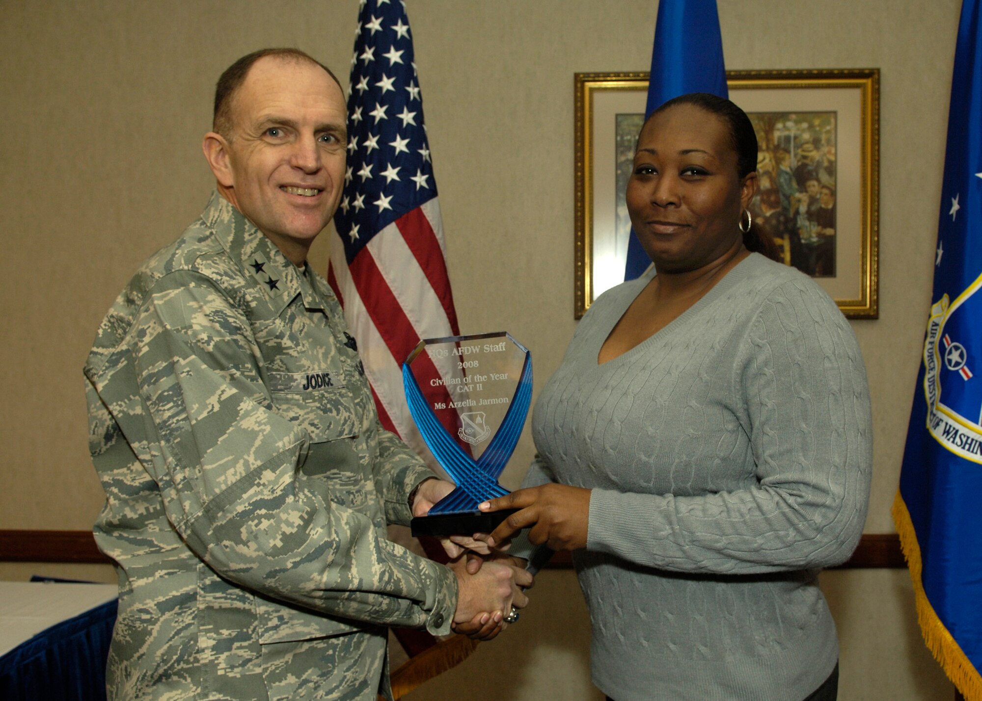 Maj. Gen. Ralph Jodice, Air Force District of Washington commander, presents the 2008 AFDW Civilian of the Year (CAT II) to Ms. Arzella Jarmon, AFDW Accounting technician. The award was presented Feb. 25 at The Club on Andrews Air Force Base, Md. 