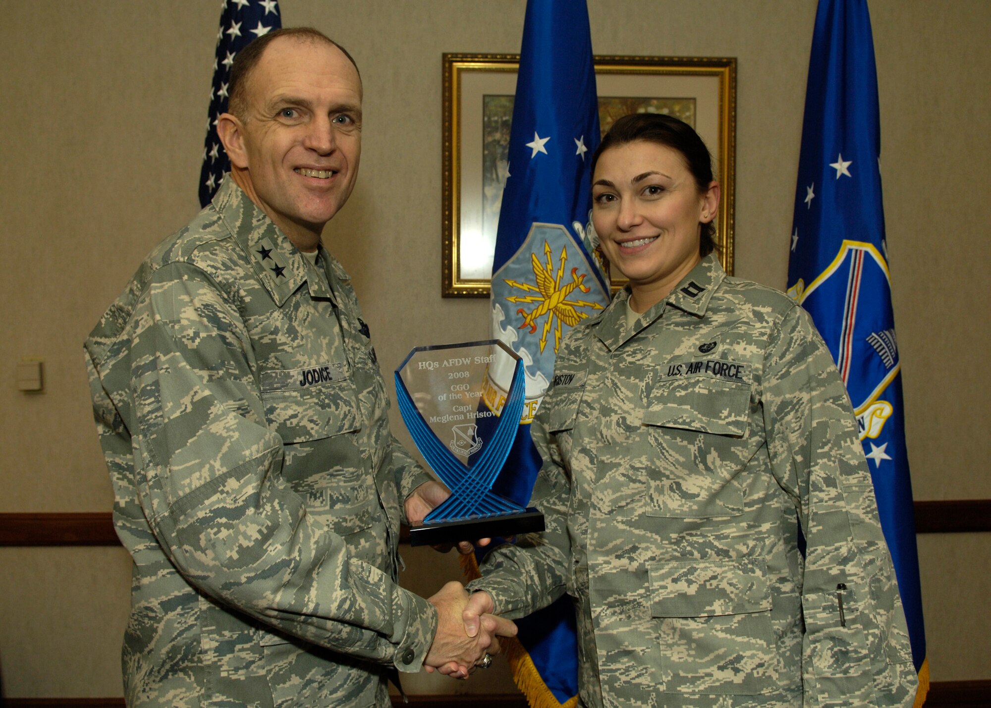 Maj. Gen. Ralph Jodice, Air Force District of Washington commander, presents the 2008 AFDW Company Grade Officer of the Year award to Capt. Meglena Hristov, AFDW Assistant Staff Judge Advocate. The award was presented Feb. 25 at The Club on Andrews Air Force Base, Md. 