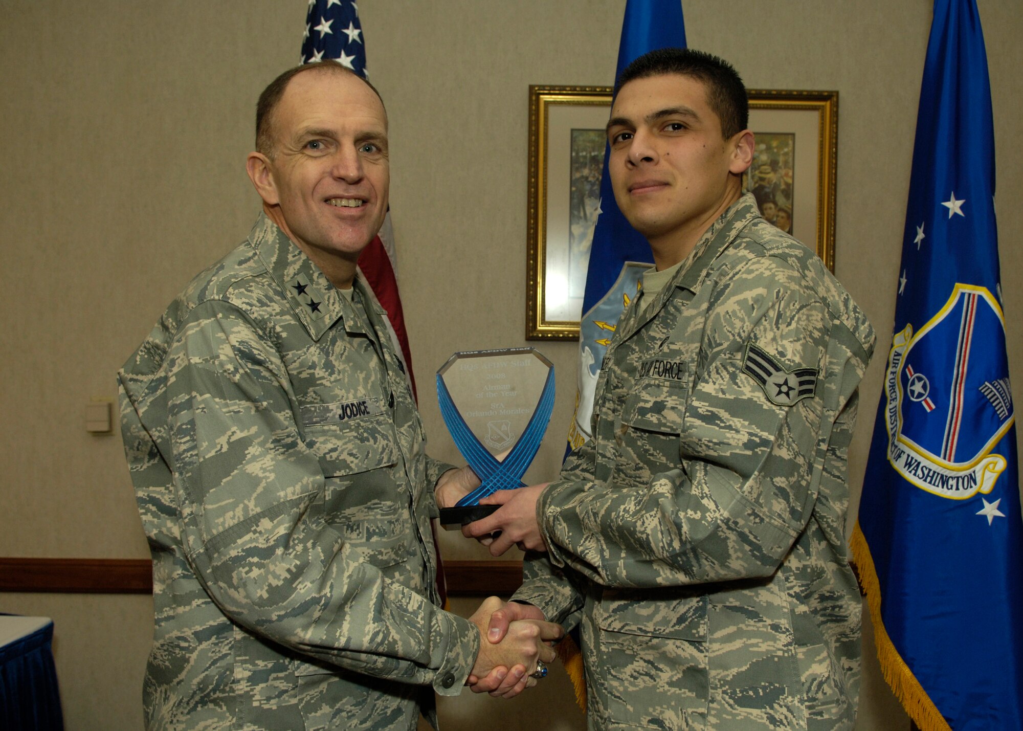 Maj. Gen. Ralph Jodice, Air Force District of Washington commander, presents the 2008 AFDW Airman of the Year award to Senior Airman Orlando Morales. The award was presented Feb. 25 at The Club on Andrews Air Force Base. 