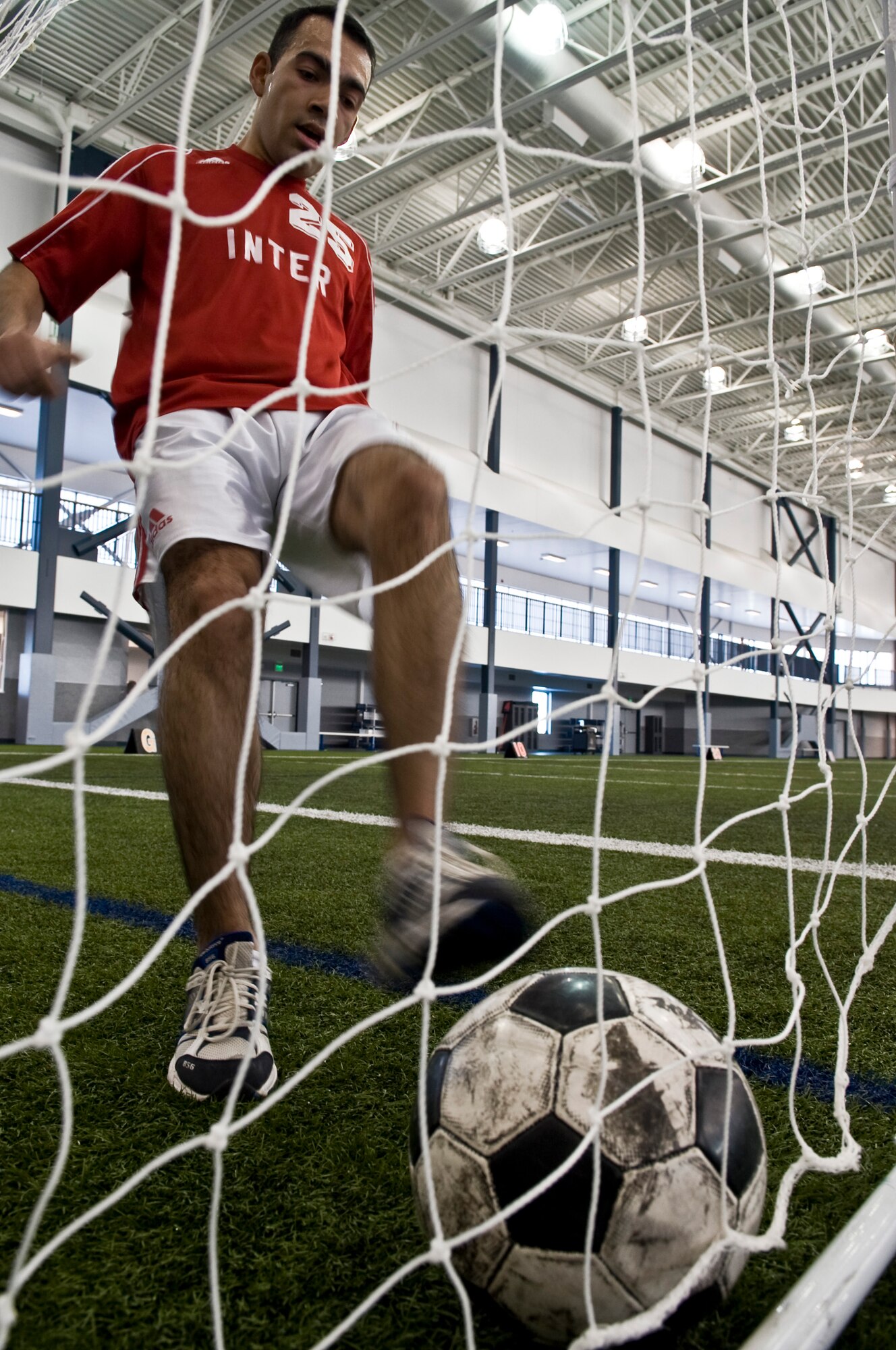Senior Airman Alex Rivera Paz, 168th Logistics Readiness Squadron supply systems technician, practices his footwork dribbling a soccer ball March 3, 2009, Eielson Air Force Base, Alaska. With the transition of becoming a more fit force, Eielson Airmen keep in shape by taking advantage of the variety of fitness programs provided by the fitness center.  (U.S. Air Force Photo/Senior Airman Christopher Griffin)
