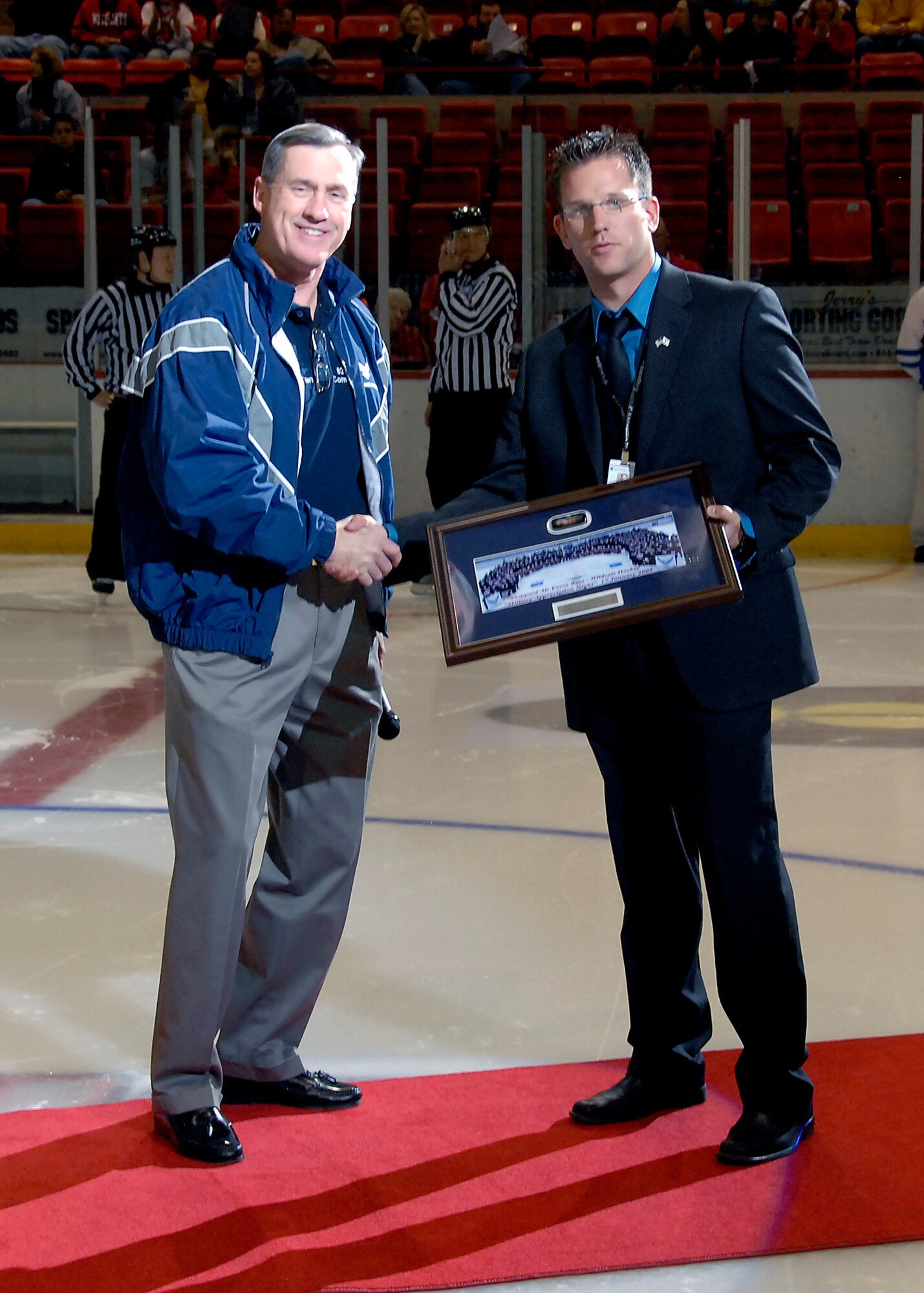 Brig. Gen. O.G. Mannon, 82nd Training Wing commander, on Feb. 27 presented a framed picture of the Wichita Falls Wildcats hockey team with over 300 Airmen, to Bryan "Moose" Panik, the Wildcats' ice program coordinator, in recognition of the Military Appreciation Night. The hockey team sponsored free tickets to Sheppard personnel and area retirees Jan. 26 with a record breaking attendance of 5,600 spectators. (U.S. Air Force photo/Mike Litteken)
