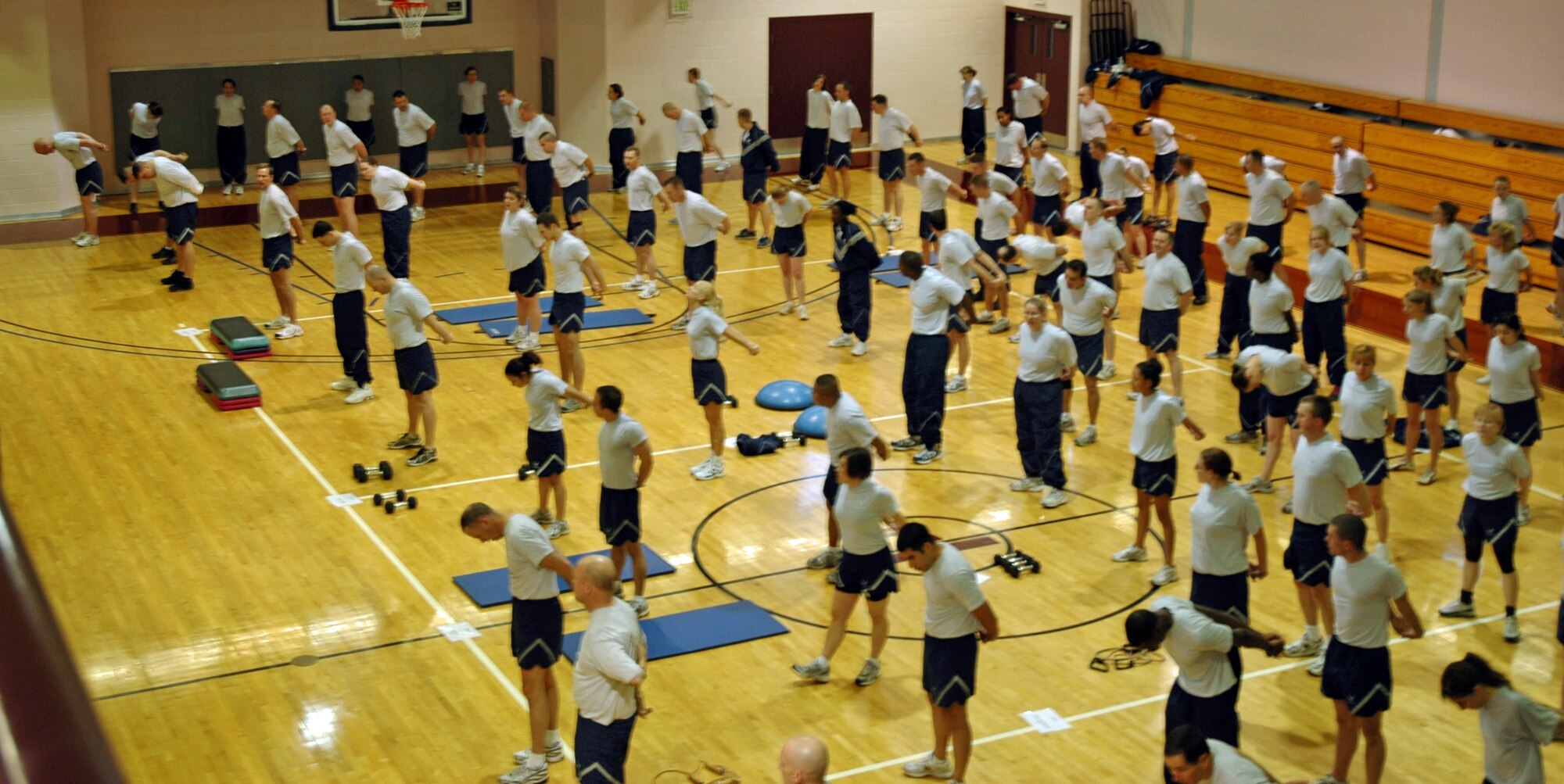 21st Space Wing Airmen perform warm-up exercises such as jogging in place, jumping jacks, pushups, mountain climbers and more at the beginning of each monthly wing War Fit. Warming up and cooling down are essential in fitness activity to avoid injury and increase flexibility.  Wing War Fit is one way the 21st Space Wing showcases one aspect of the mission:  Developing and deploying Warrior Airmen to defend America and our Allies.