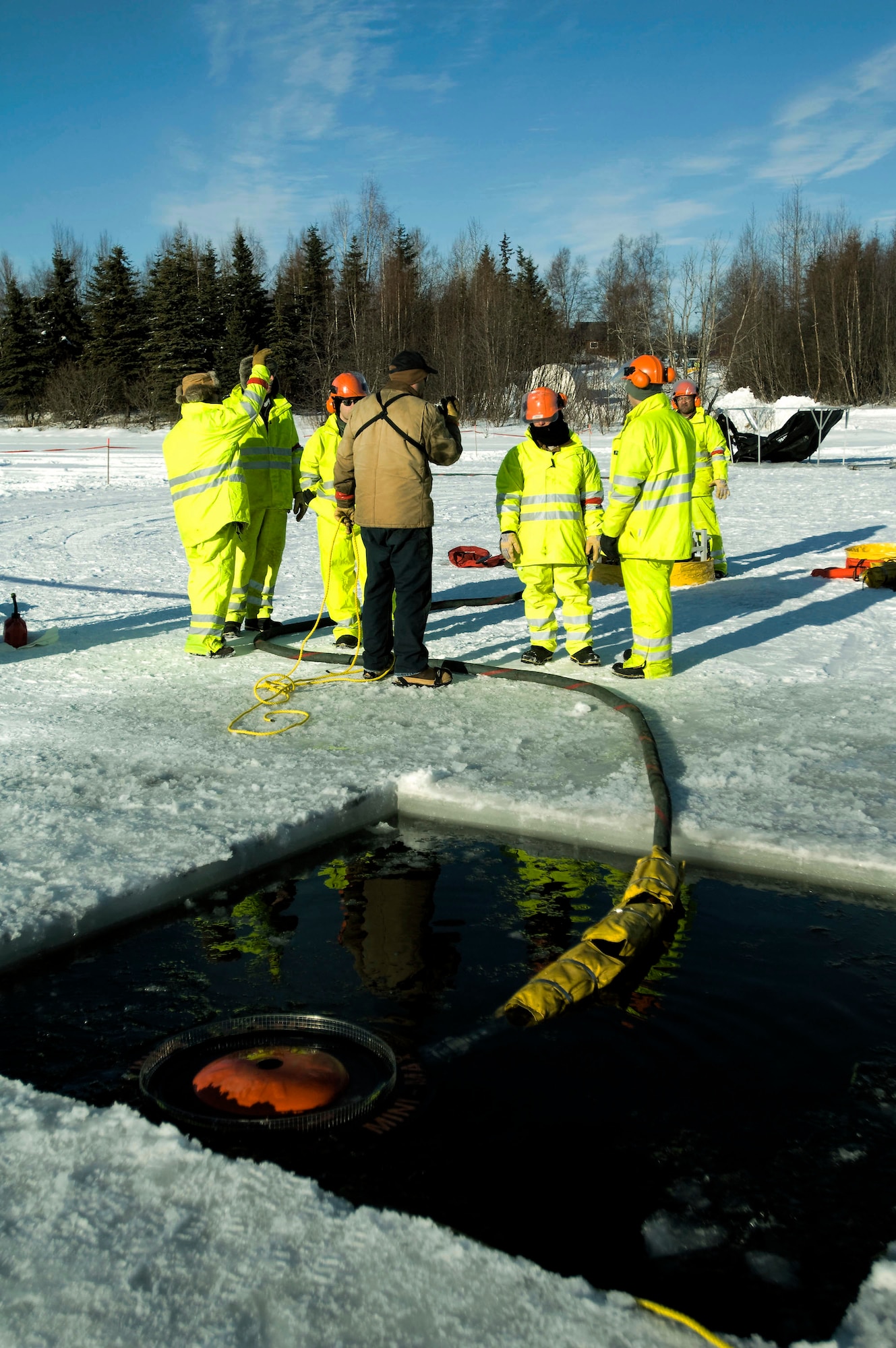 Ice Ops participants use a Weir skimmer to suck water and oil into a filter plate. Several Airmen were on the base's Six-mile Lake to practice oil spill recovery tactics at Elmendorf Air Force Base, Alaska. (U.S. Air Force photo/Senior Airman Jonathan Steffen)