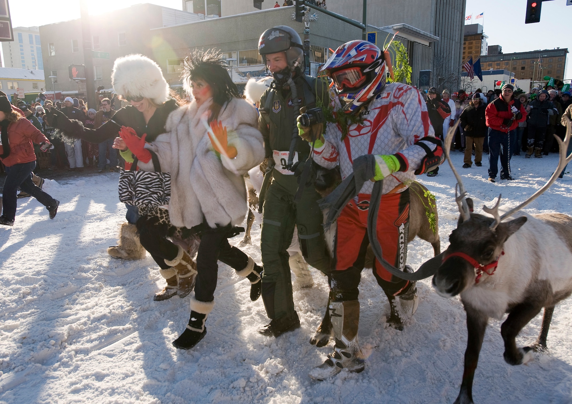 ANCHORAGE, Alaska -- Col. Eric Overturf and his wife, Karla, (both in the middle) run through the streets of Anchorage during the second annual Running of the Reindeer here. The Overturfs ran in the celebrity heat, running two city blocks with a herd of reindeer darting through the crowd. Colonel Overturf, an F-22 Raptor pilot, is the 477th Fighter Group commander at Elmendorf Air Force Base, Alaska. The 477th Fighter Group is Air Force Reserve Command's first F-22A Raptor unit and the first Reserve flying unit based in the Pacific theater of operations. (U.S. Air Force photo by Master Sgt. Keith Brown)