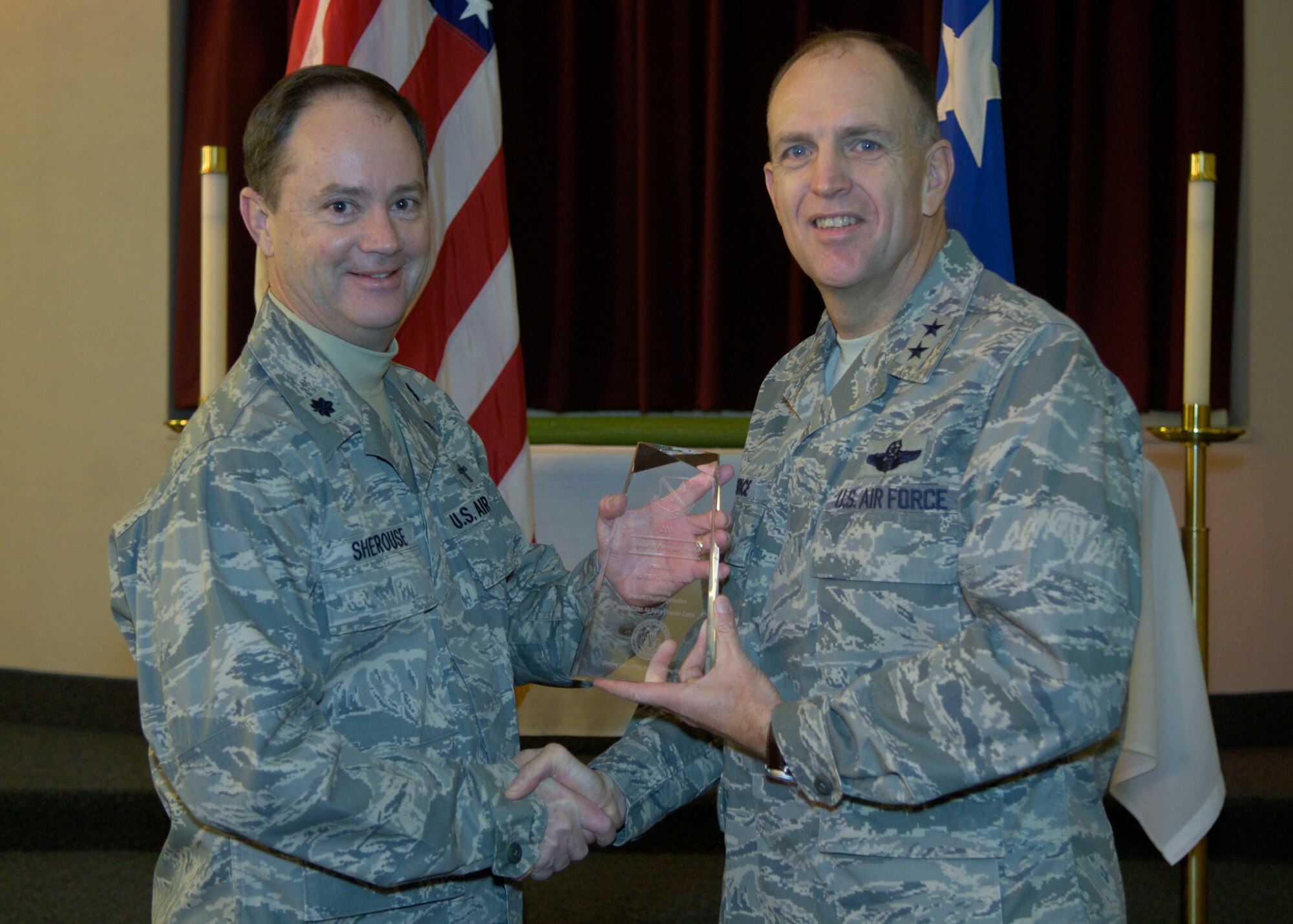 Maj. Gen. Ralph Jodice, Air Force District of Washington commander, presents the AFDW Outstanding Medium Chapel Organization Award to Chaplain (Lt. Col.) Paul Sherouse, 316th Wing Chaplain. The award presentation, which honors staff of the Andrews Air Force Base, Md., Chaplain Corps, took place Feb. 25, 2009, at the Andrews chapel.  (U.S Air Force photo by Senior Airman Renae Kleckner.)