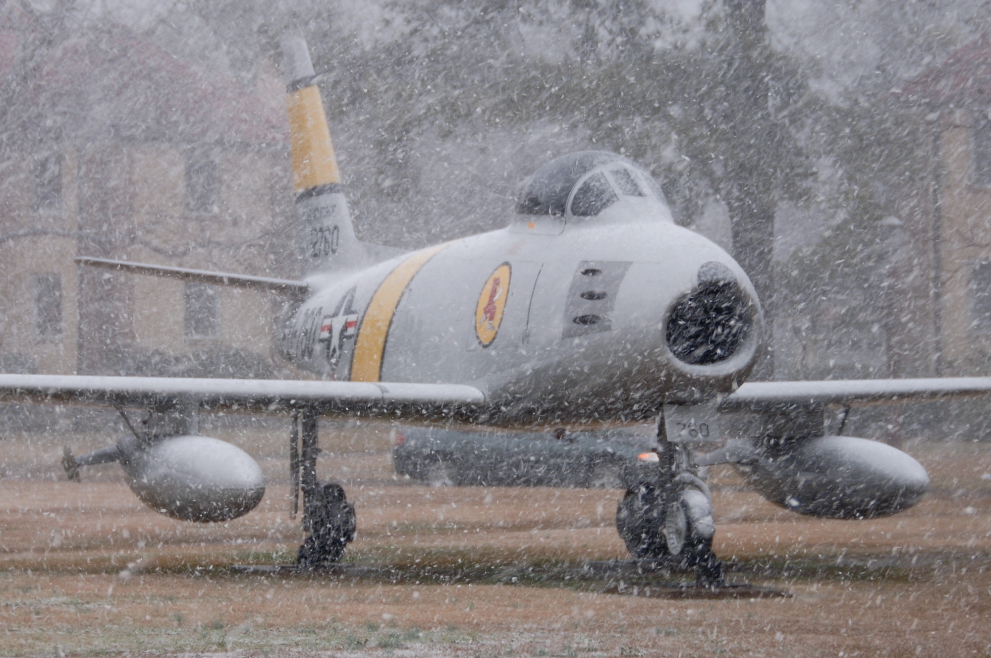 Snow falls in front of an F-86 Sabre at the Maxwell Air Park on Sunday. Although the snow on base measured nearly one inch by morning, the snow melted off by noon. (Air Force photo by Donna Burnett)
