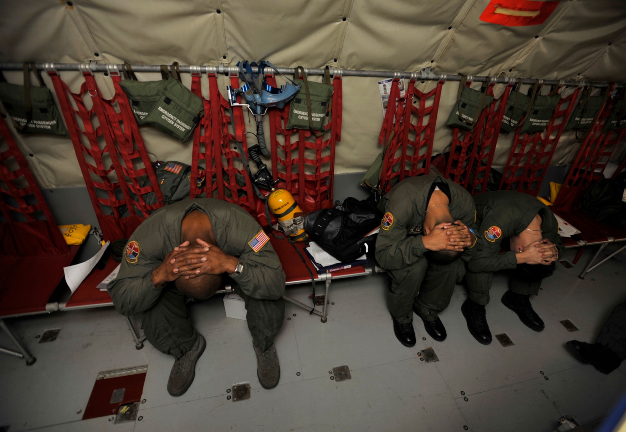 Airmen assigned to the 514th Aeromedical Evacuation Squadron at McGuire Air Force Base, N.J., practice procedures for a crash landing while flying on a KC-135 Stratotanker Friday. The KC-135 was flown by Airmen from the 931st Air Refueling Group at McConnell Air Force Base, Kan. The two units teamed up for an aeromedical evacuation training mission from Feb. 27 to March 1. (U.S. Air Force photo/Tech. Sgt. Jason Schaap) 