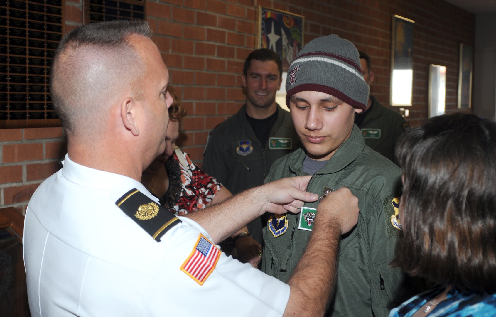 Randolph Fire Chief Mark Ledford places a pin on Jared Garza during Pilot for a Day. (U.S. Air Force photo by Steve White)