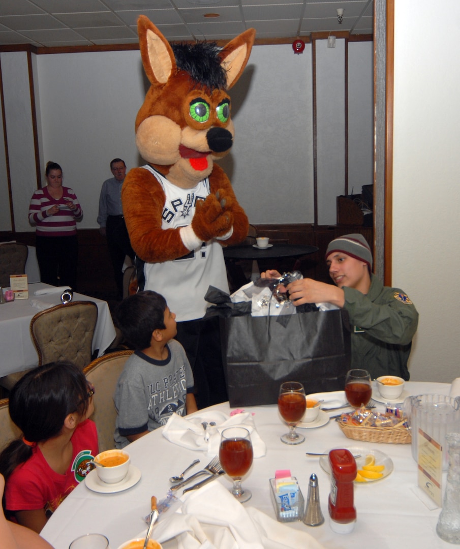 The Spurs Coyote entertains Pilot for a Day Jared Garza and his family. (U.S. Air Force photo by Steve White)