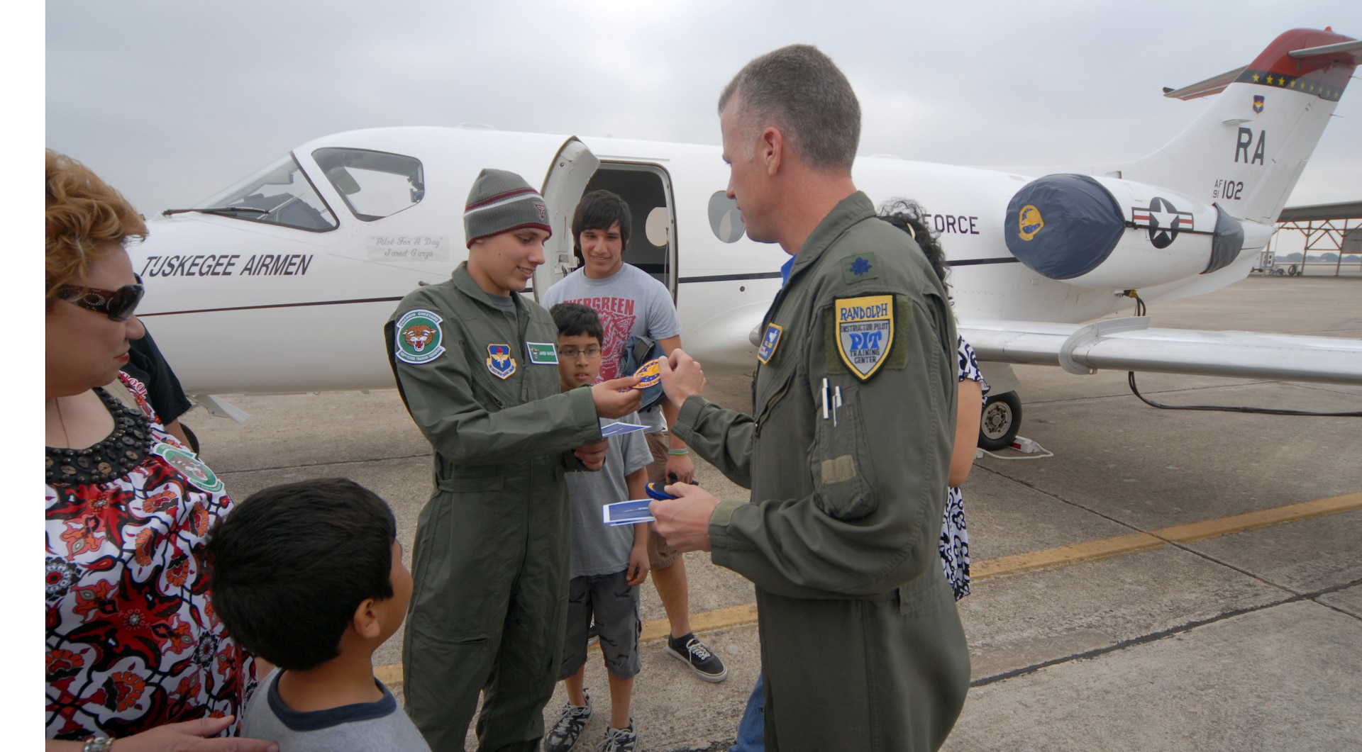 Lt. Col. Bill Lockhart, 99th Flying Training Squadron, gives Jared Garza a squadron patch during Pilot for a Day. (U.S. Air Force photo by Steve White)