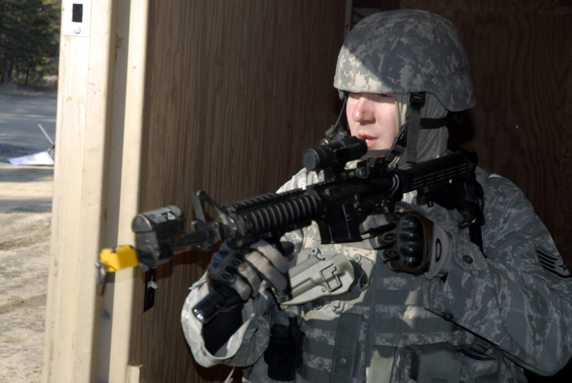 A student in the Air Force Phoenix Warrior Training Course practices tactics for military operations in urban terrain during training on Naval Air Engineering Station Lakehurst, N.J., on Feb. 23, 2009.  The course, taught by the U.S. Air Force Expeditionary Center's 421st Combat Training Squadron at Fort Dix, N.J., prepares security forces Airmen for upcoming deployments.  (U.S. Air Force Photo/Staff Sgt. Paul R. Evans)
