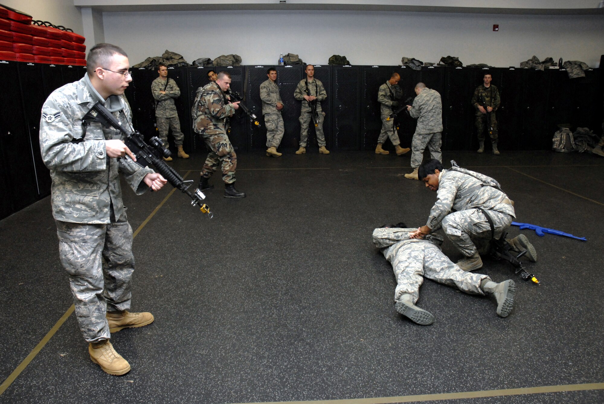 Students in the Air Force Phoenix Warrior Training Course practice tactics for military operations in urban terrain during "tape drills" inside a training room in the U.S. Air Force Expeditionary Center on Fort Dix, N.J., on Feb. 23, 2009.  The course, taught by the center's 421st Combat Training Squadron, prepares security forces Airmen for upcoming deployments.  (U.S. Air Force Photo/Staff Sgt. Paul R. Evans)