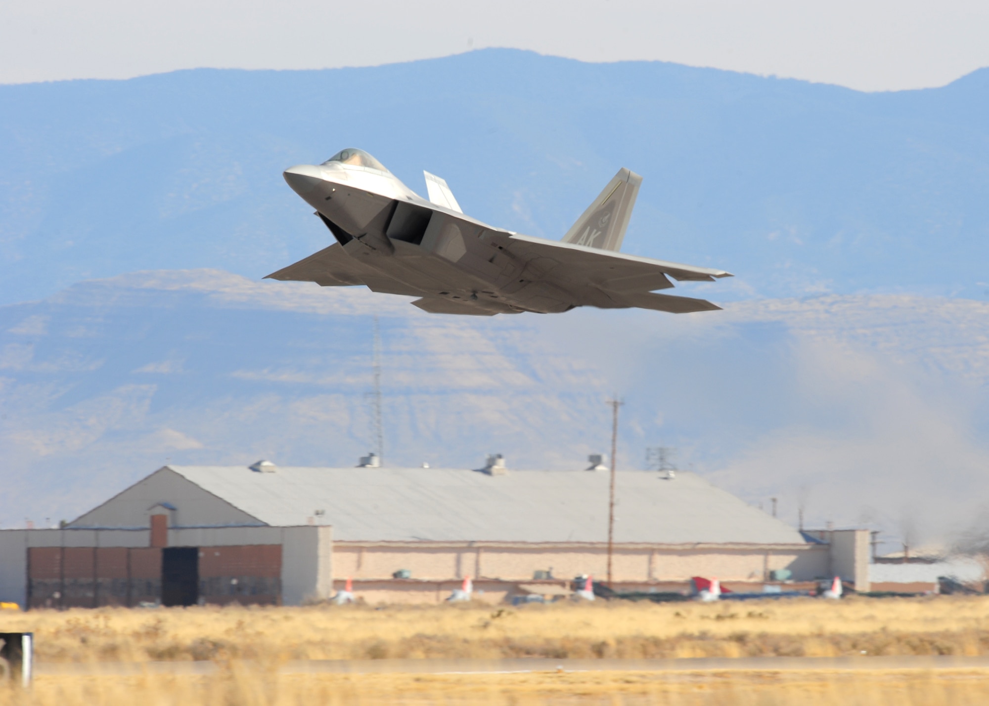 An F-22A Raptor departs Holloman Air Force Base, Nm on its way home to Elmendorf AFB, Ak 3 Mar. Fourteen Raptors were deployed to Holloman to avoid volcanic activity at thier home station. (U.S. Air Force Photo/TSgt Chris Flahive)