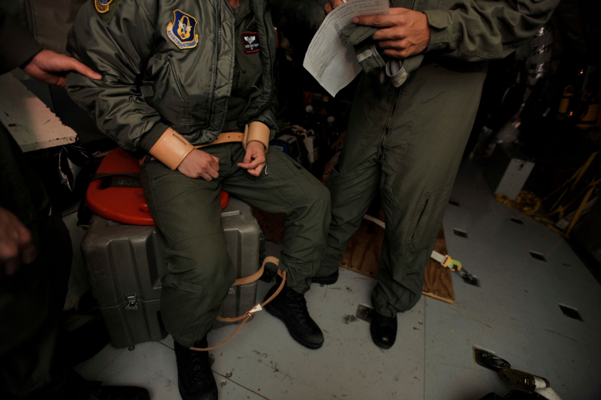 An Airman who became out of control is constrained and questioned by medical personnel during an aeromedical evacuation training exercise Sunday. The constrained Airman acted the part of a violent psychiatric patient so that Reservists assigned to the 514th Aeromedical Evacuation Squadron could learn how to handle such a situation while in flight aboard a KC-135 Stratotanker. Reservists from the 931st Air Refueling Group at McConnell Air Force Base, Kan., flew the KC-135 during the three-day training mission. (U.S. Air Force photo/Tech. Sgt. Jason Schaap)