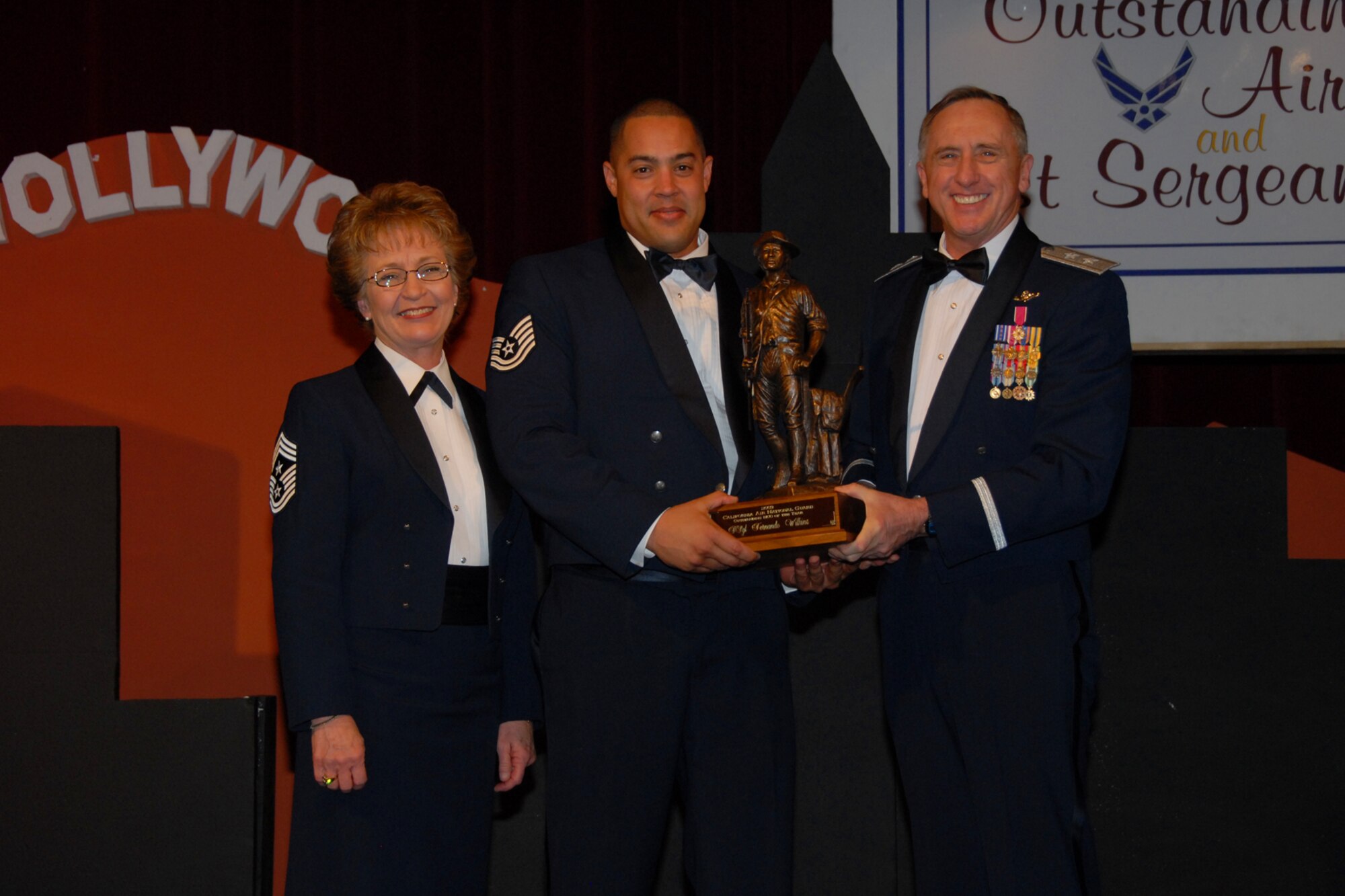 Tech. Sgt. Fernando Wilkins receives the California Air National Guard's NCO of the Year award from Maj. Gen. Dennis G. Lucas, Commander of the California Air National Guard, and Chief Master Sgt. Deborah K. Lott, California Air National Guard Command Chief, during the Outstanding Airman of the Year Banquet Jan. 17 in Riverside, Calif. (Photo courtesy of the California Air National Guard)
